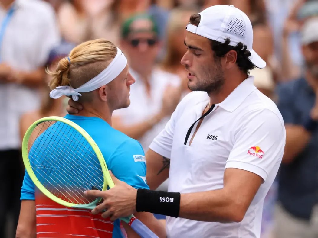 Berrettini and Fokina greet each other at the net