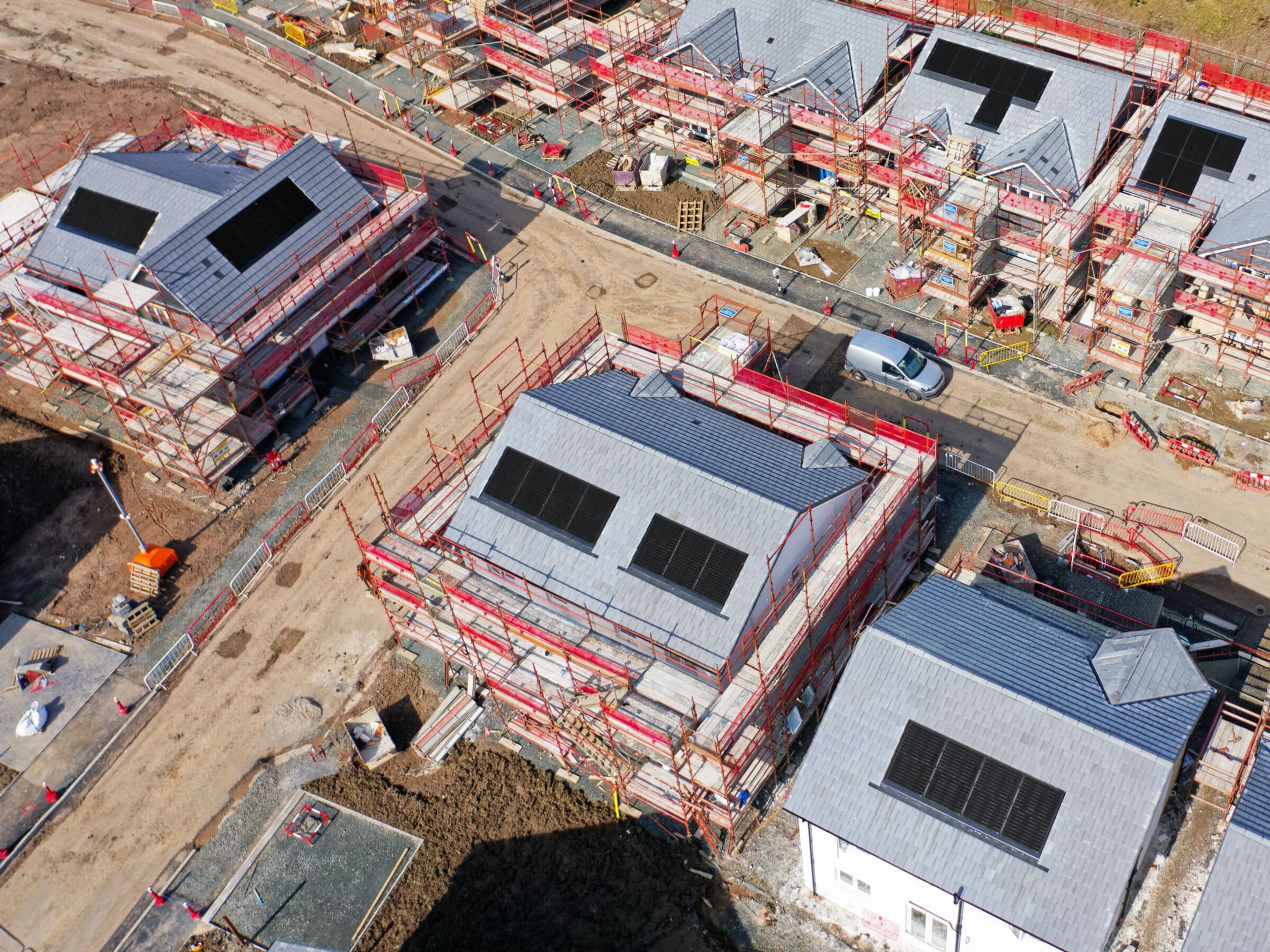 Aerial view of new-build homes with solar panels integrated during construction