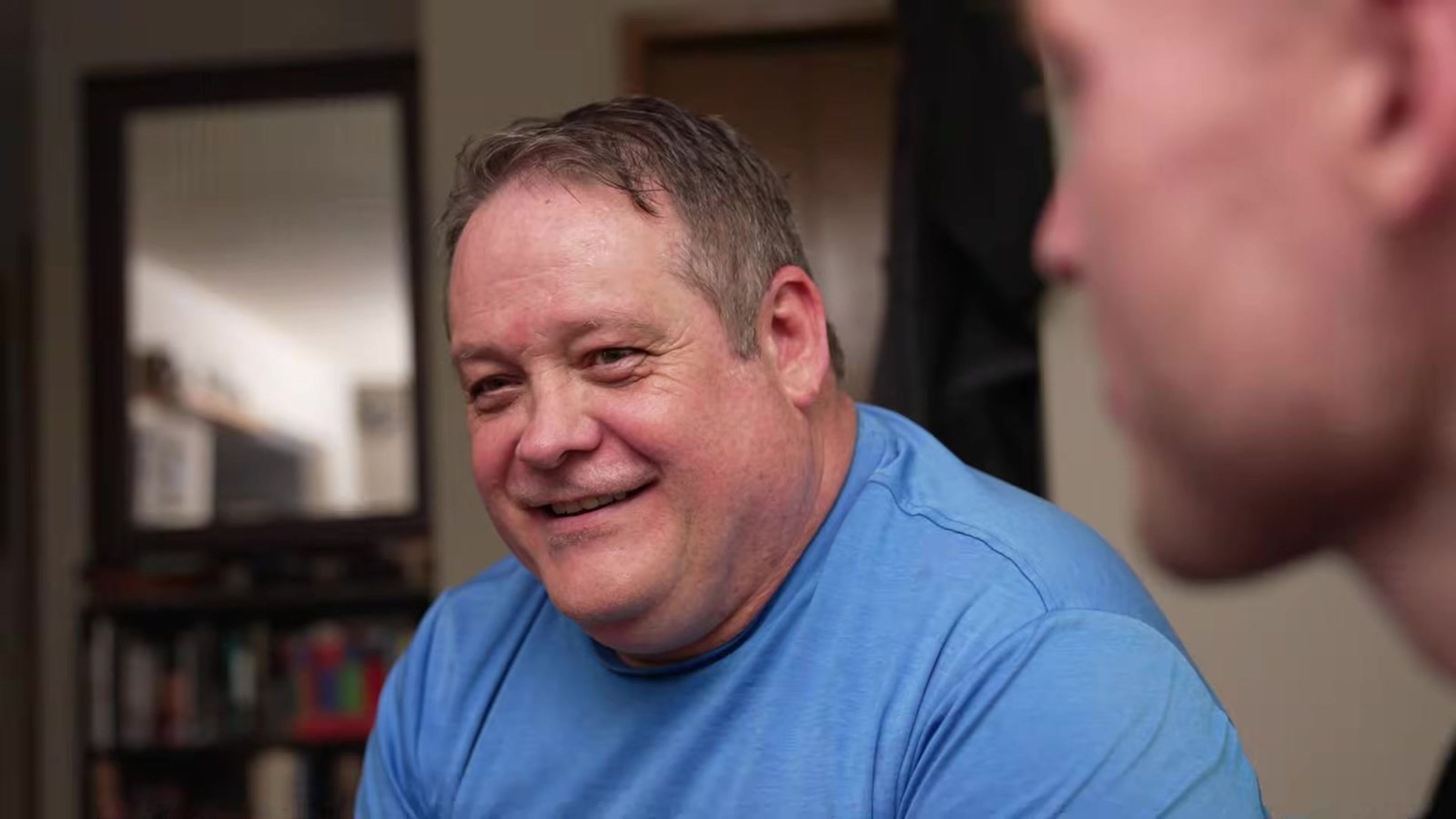Paul laughing with his Firefly Solar representative at home