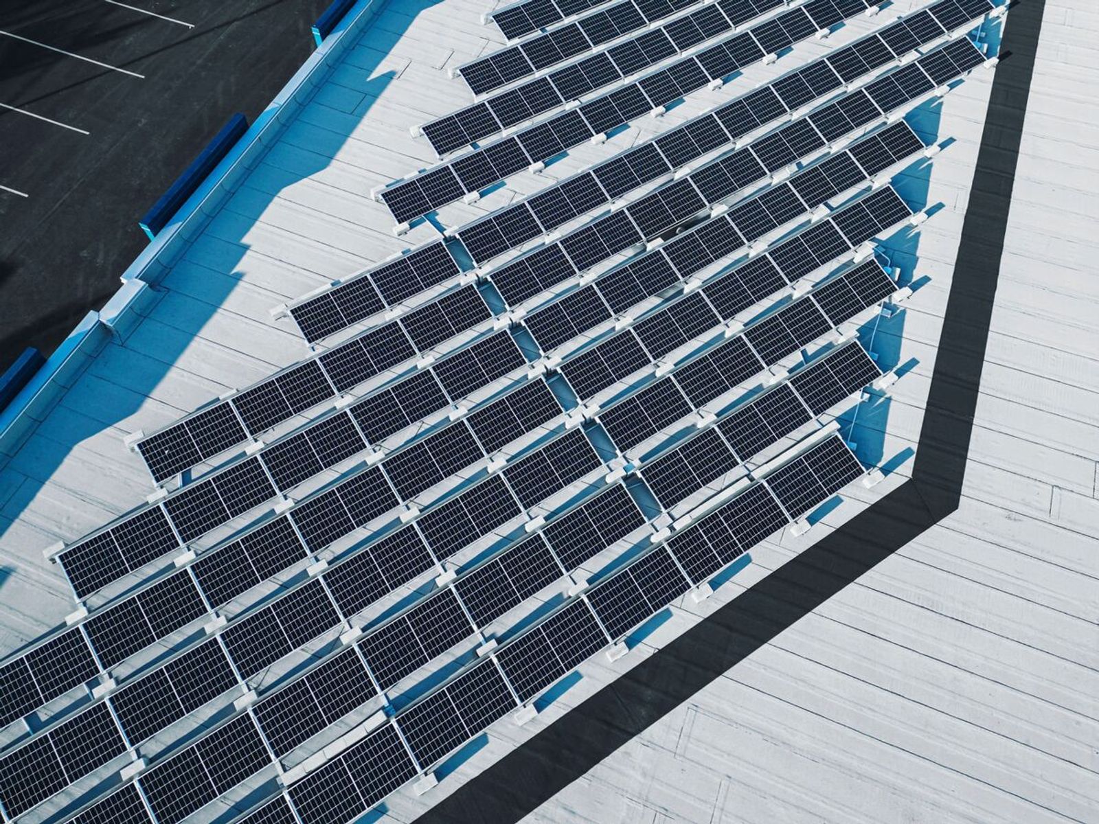 Aerial view of commercial flat-roof solar panel array on office building
