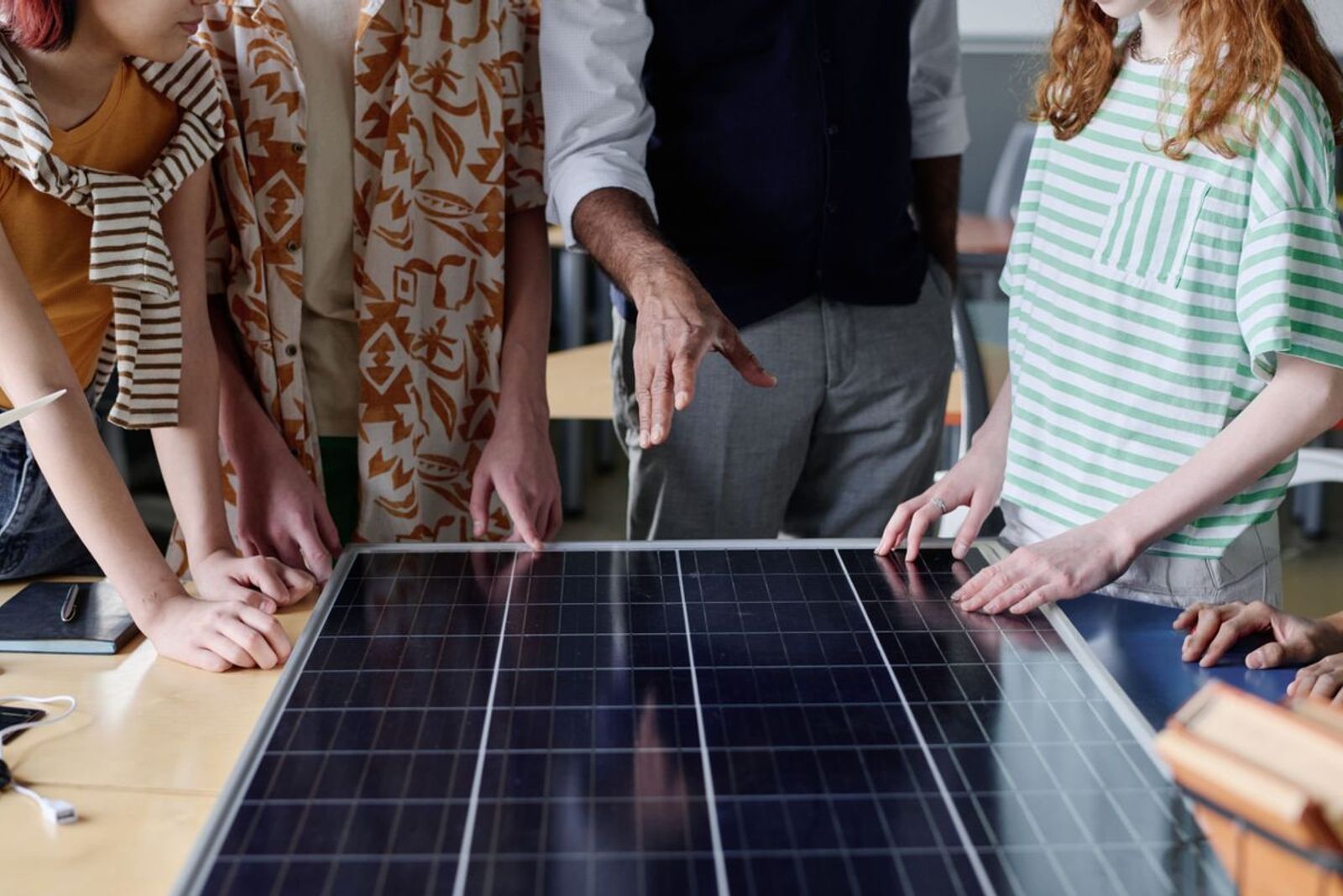 Indigenous community members receiving hands-on solar installation training and employment