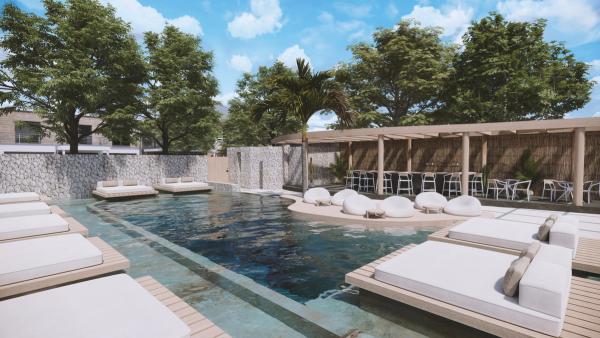 Piscină modernă în aer liber, cu șezlonguri albe, plante verzi și un bar acoperit, sub un cer senin.