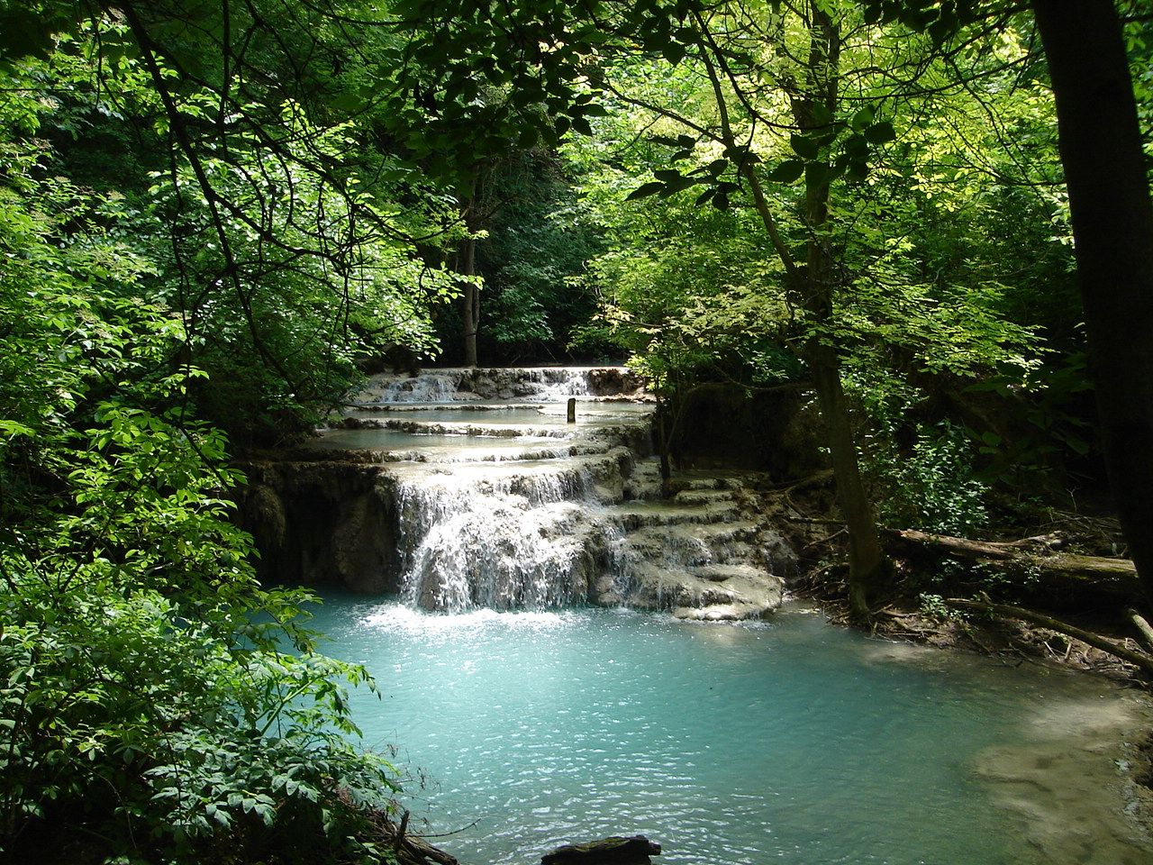 A waterfall and turquoise pool at Krushuna