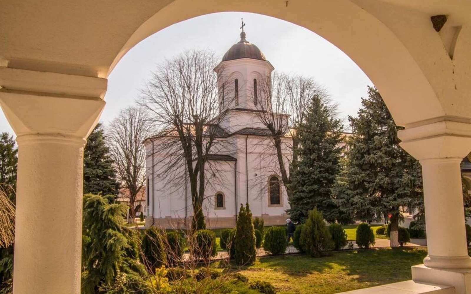 The Ghighiu Monastery church, seen through an arch