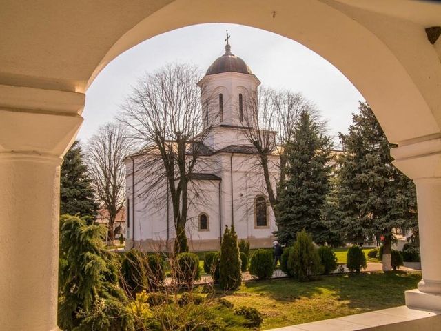 The Ghighiu Monastery church, seen through an arch