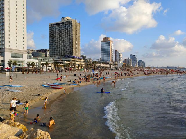 People on the beach along the Tel Aviv promenade
