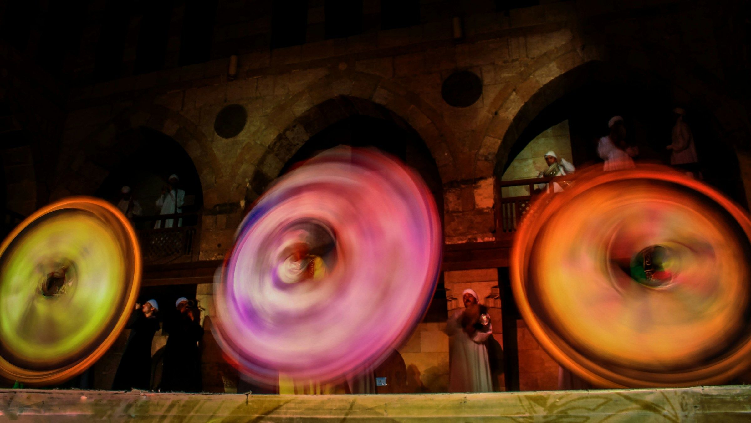 Tanoura dancers spinning in the light in Cairo