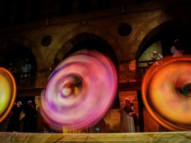 Tanoura dancers spinning in the light in Cairo