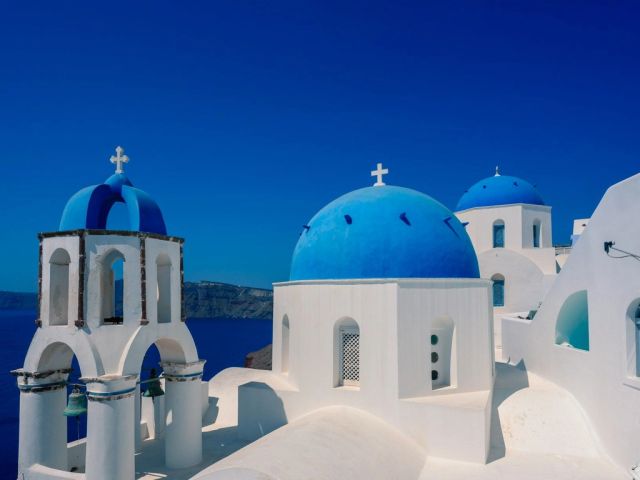 White churches with blue domes in Santorini