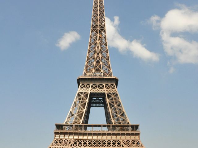 The Eiffel Tower in Paris against a cloudy sky