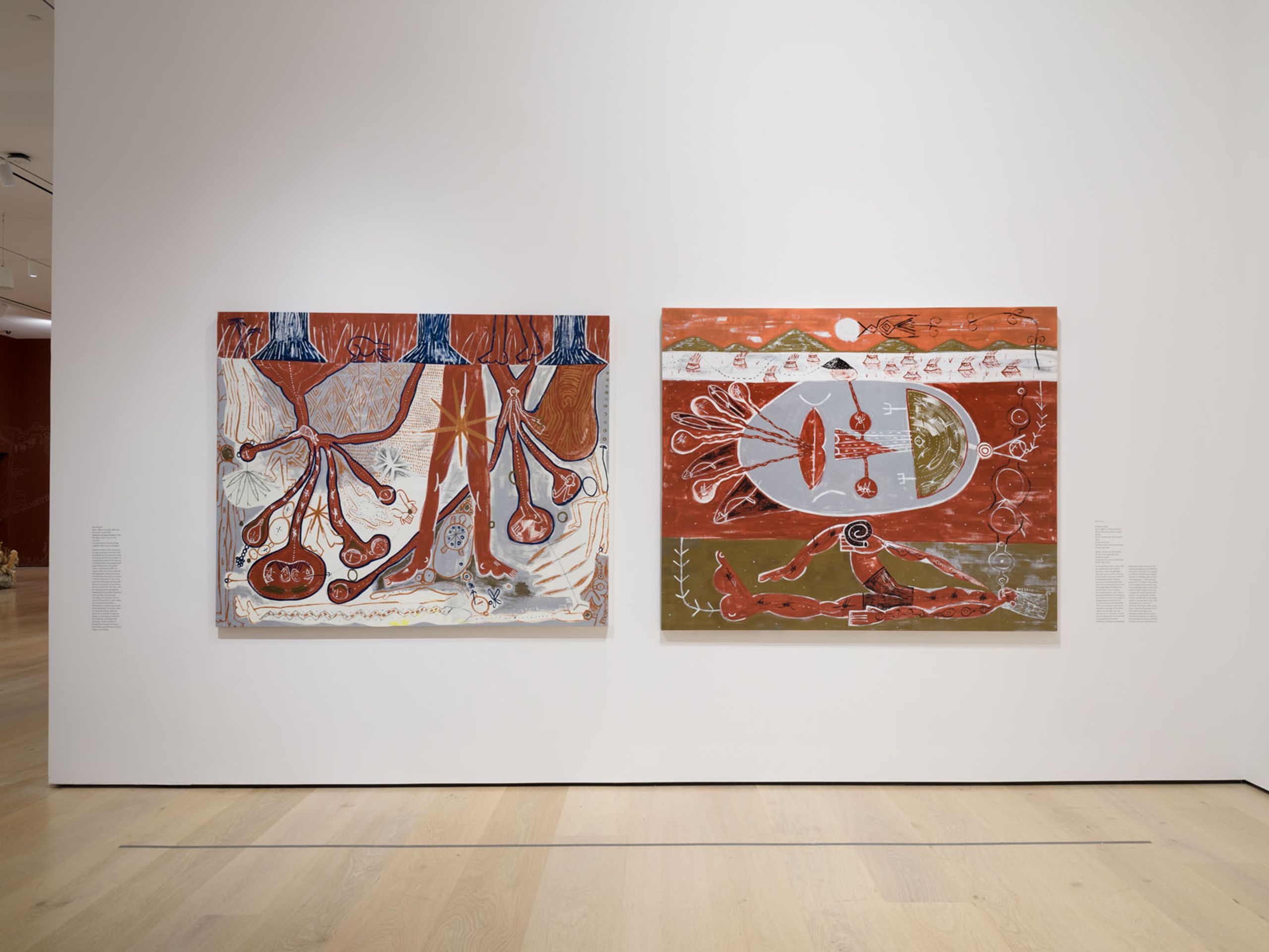 Two large abstract paintings with biomorphic and figurative elements in earthy tones hang on a white gallery wall.