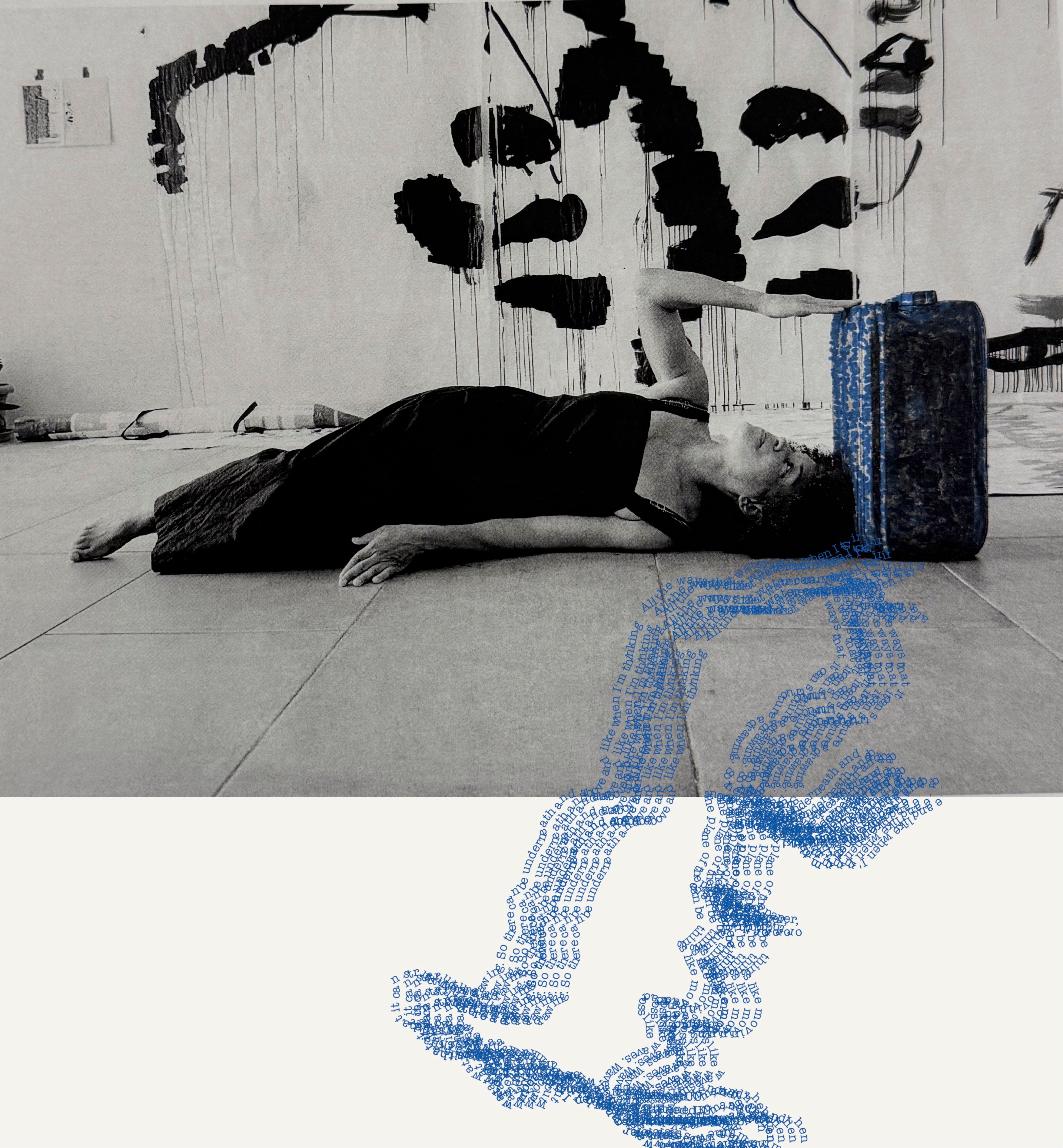 A woman lies on a floor with her arm on a blue suitcase, as blue digital patterns flow below. Abstract black art adorns the wall.