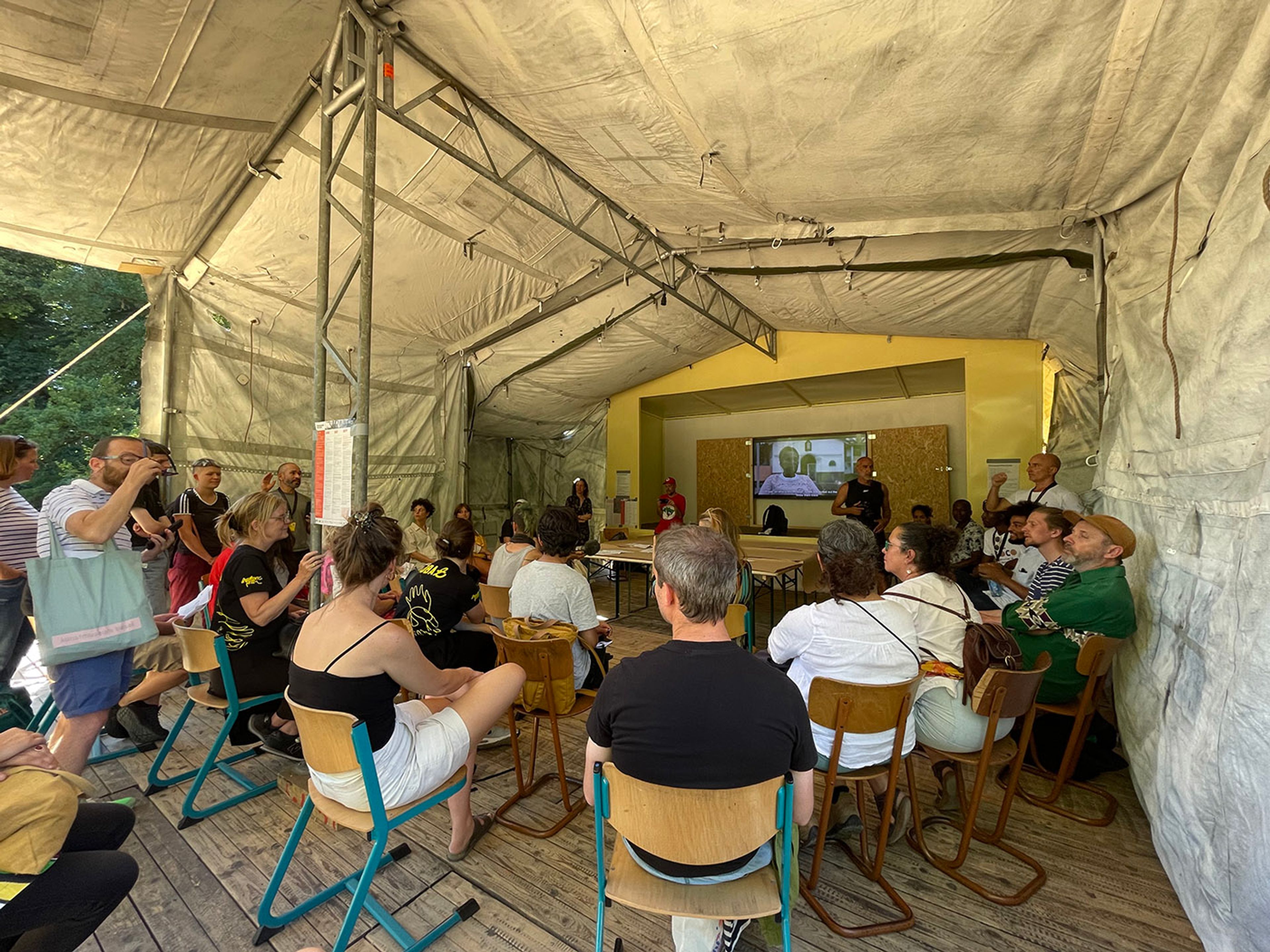 Group discusses the experience of walking through the park at MAMA Doc Space, created in collaboration with Más Arte Más Acción and Atelier Van Lieshout in Karlsaue Park, at documenta15 in Kassel. Photo: C&amp;AL