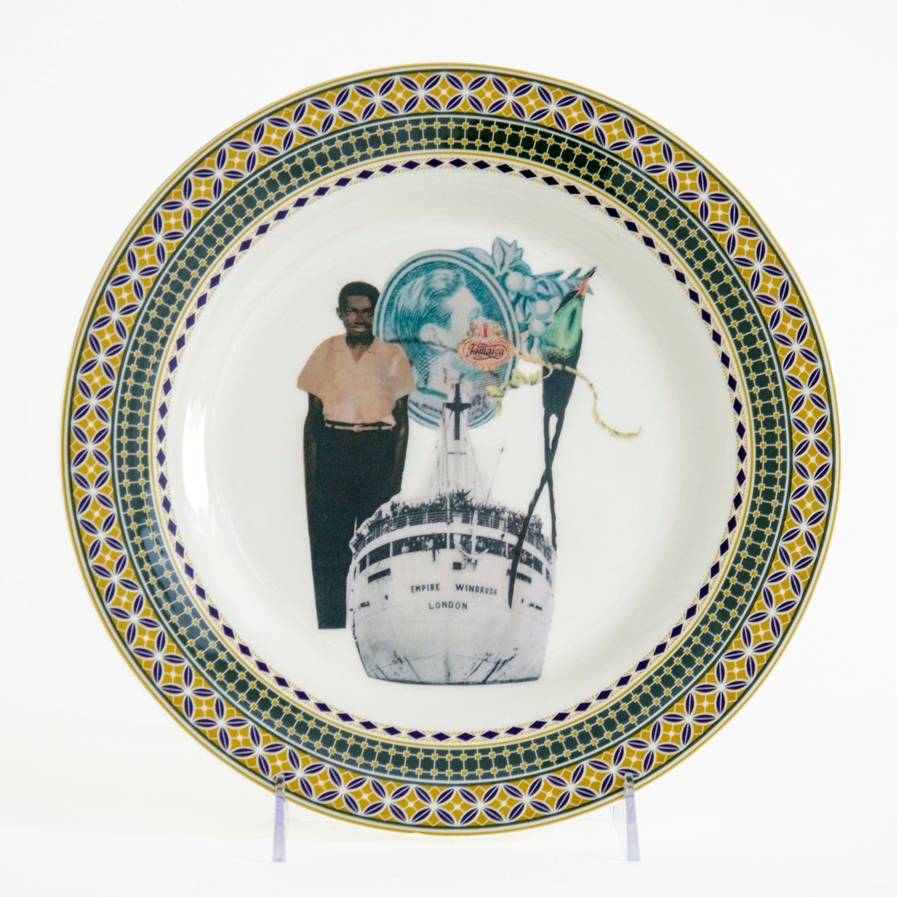 A decorative plate featuring a collage of a standing person, the ship Empire Windrush, and other symbolic imagery, surrounded by an ornate border.