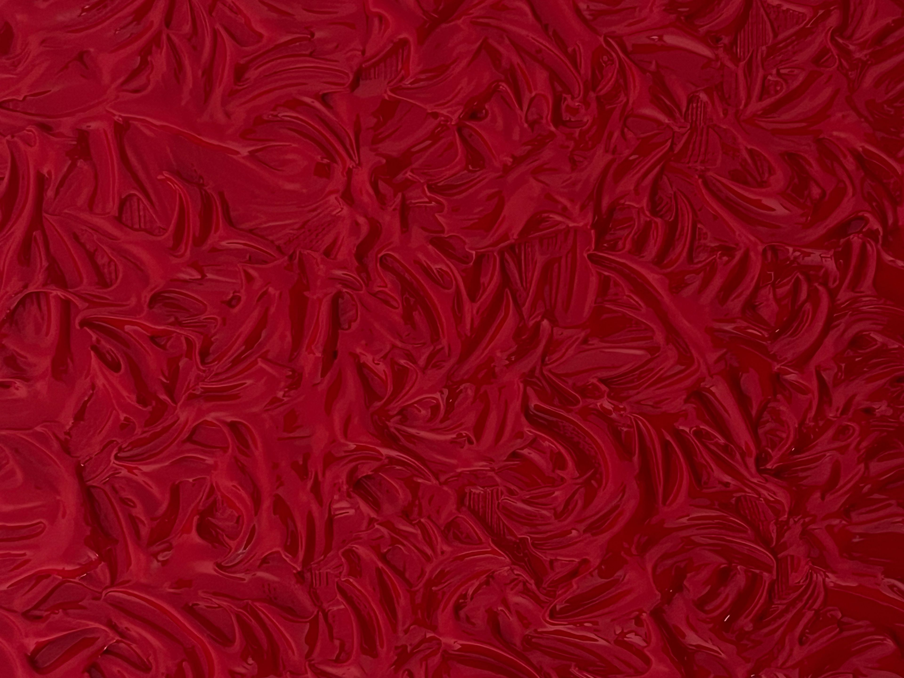 Glossy, dark red swirled texture.
