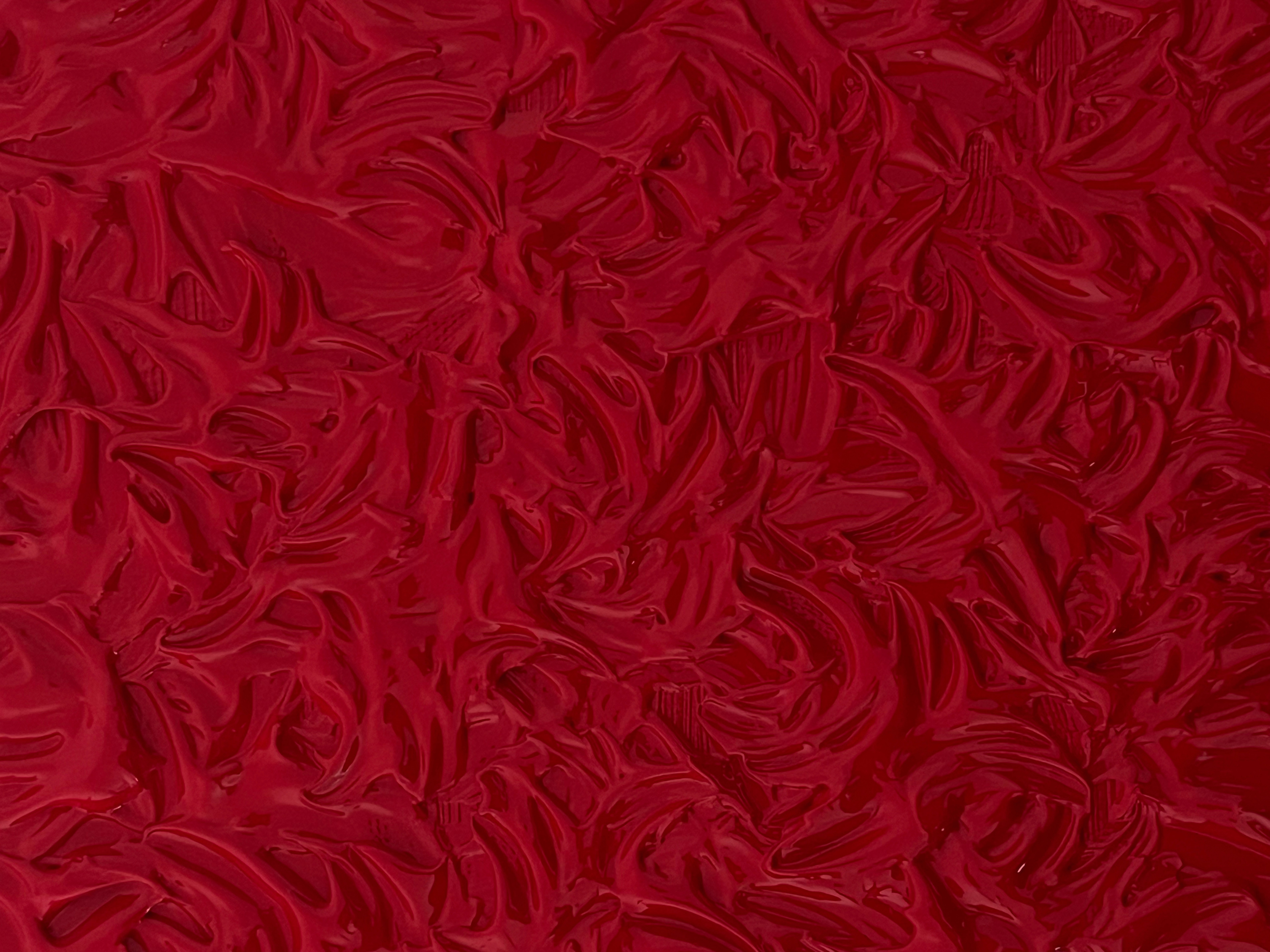 Glossy, dark red swirled texture.