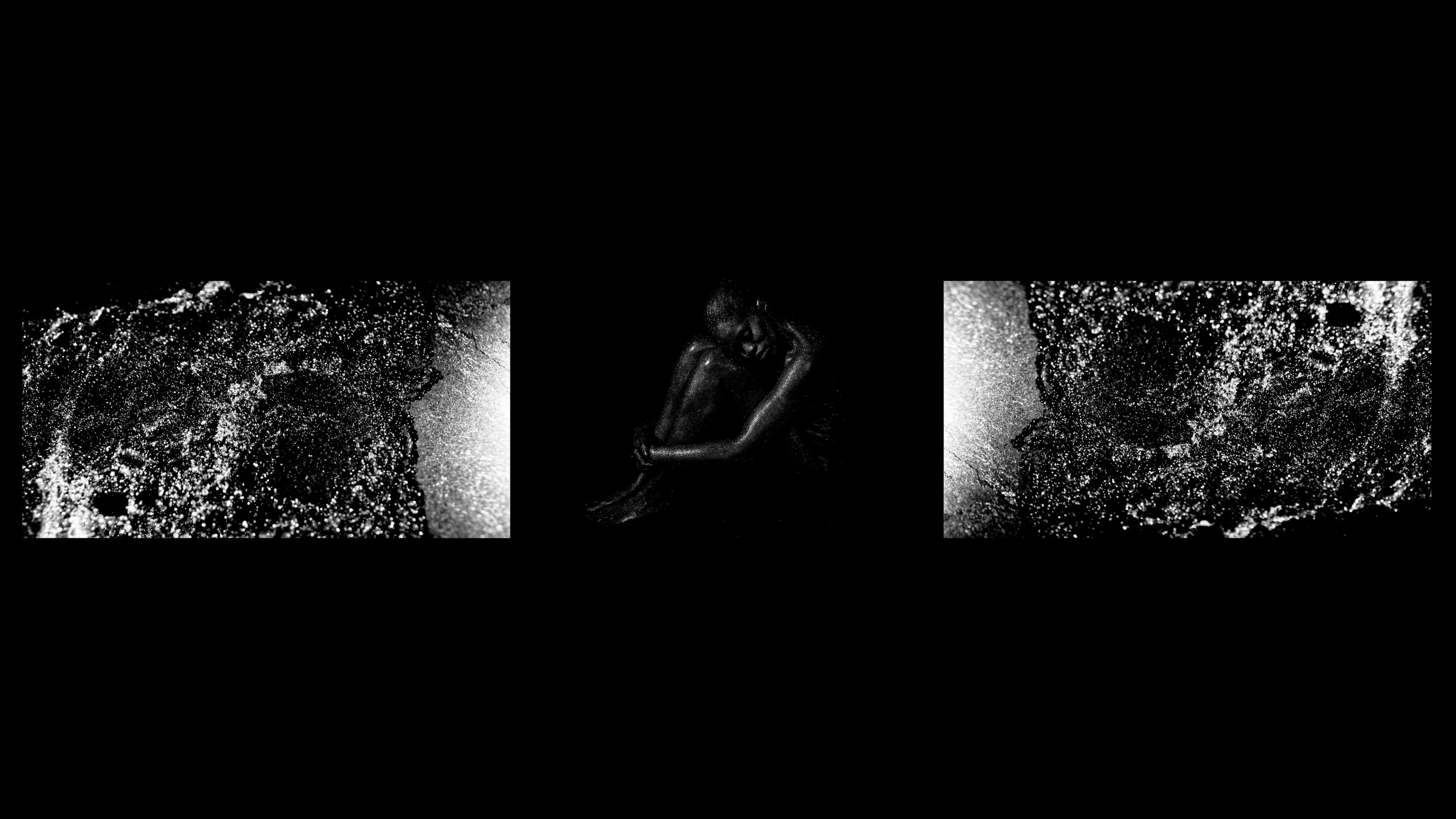 A monochromatic image of a dark, hunched figure seated in the center, flanked by two abstract, textured black and white panels.
