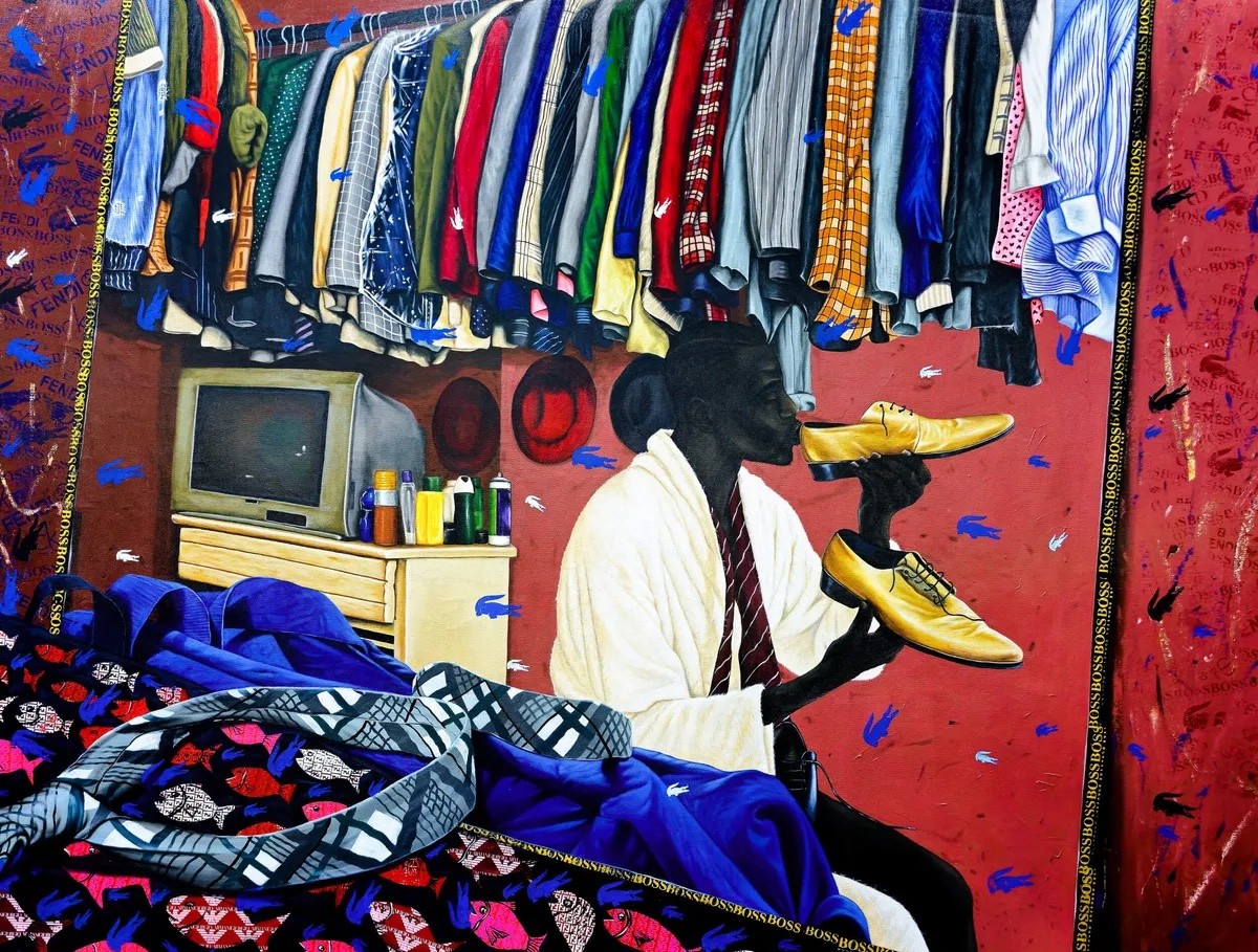 A vibrant painting depicts a Black man in a white robe and tie holding golden shoes, surrounded by a dense wardrobe and prominent designer logos on a red wall.