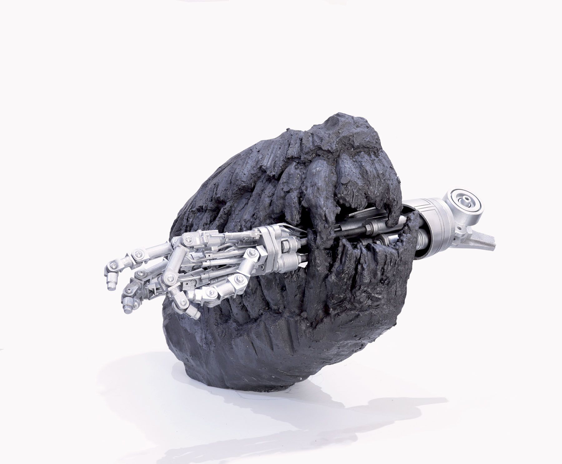 Silver robotic arm emerging from a dark, rough meteorite.