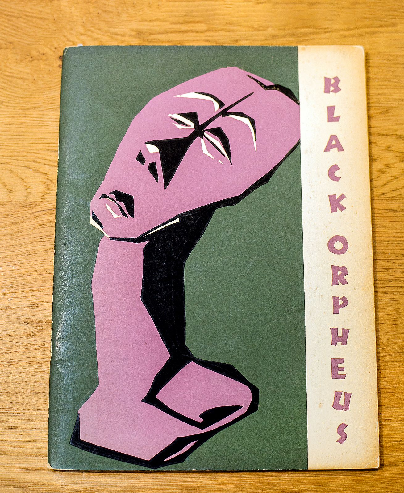 Cover of Black Orpheus magazine featuring a stylized pink and black angular head on a dark green background.
