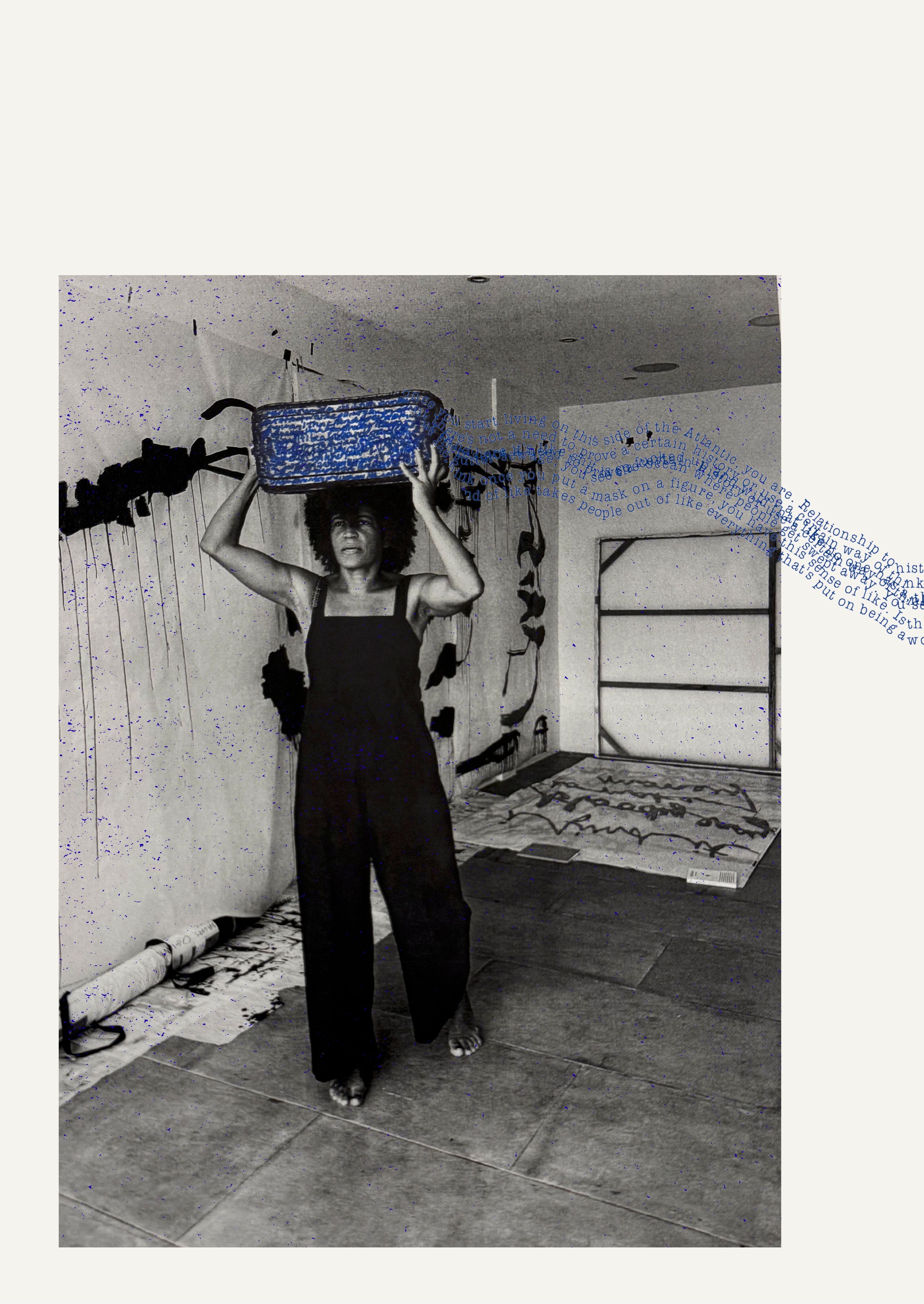 A barefoot Black woman in a black jumpsuit balances a blue woven basket on her head in a paint-splattered studio. The black and white photo has blue text overlay and speckles.