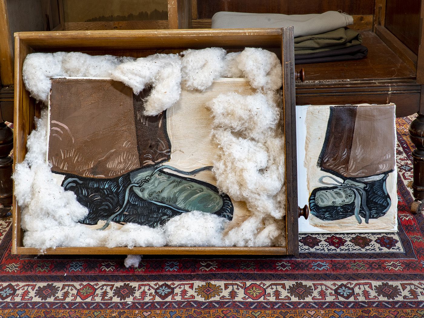 Ali Eyal (Iraq, 1994), “The blue ink pocket, and”, oil on canvas, wardrobe, raw cotton, rice, woven carpet, conté stick dimensions variable, 2022. Brief Histories, NYC.