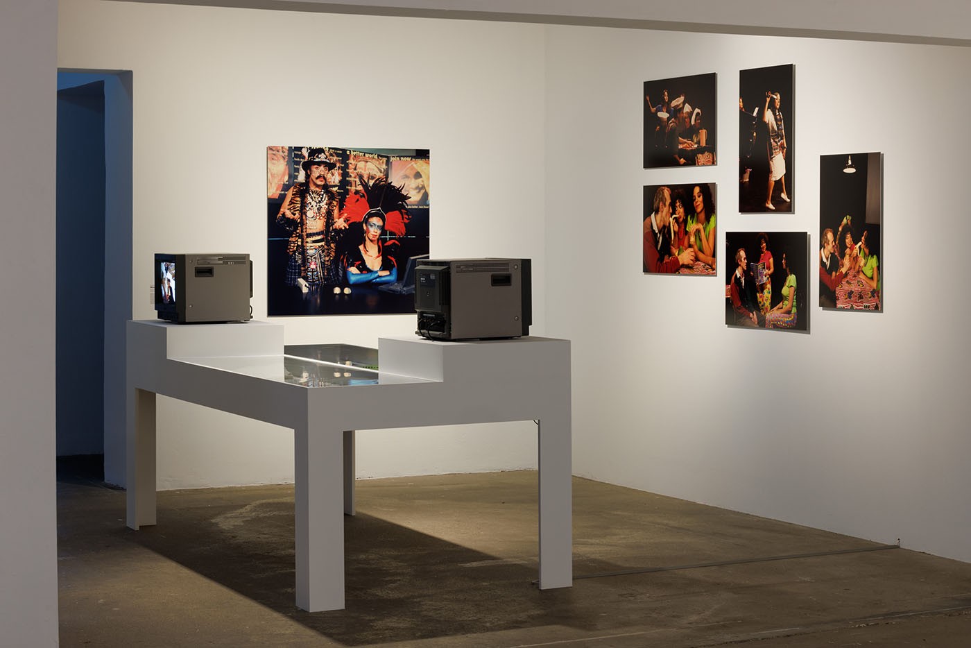 Coco Fusco with Guillermo Gómez-Peña, Mexarcane International, 1994-1995. Courtesy the artist (back left). Coco Fusco with Nao Bustamante, Stuff, 1996-1999. Courtesy the artist (right). Installation view of the exhibition “Coco Fusco – Tomorrow, I Will Become an Island” at KW Institute for Contemporary Art, Berlin 2023; Photo: Frank Sperling