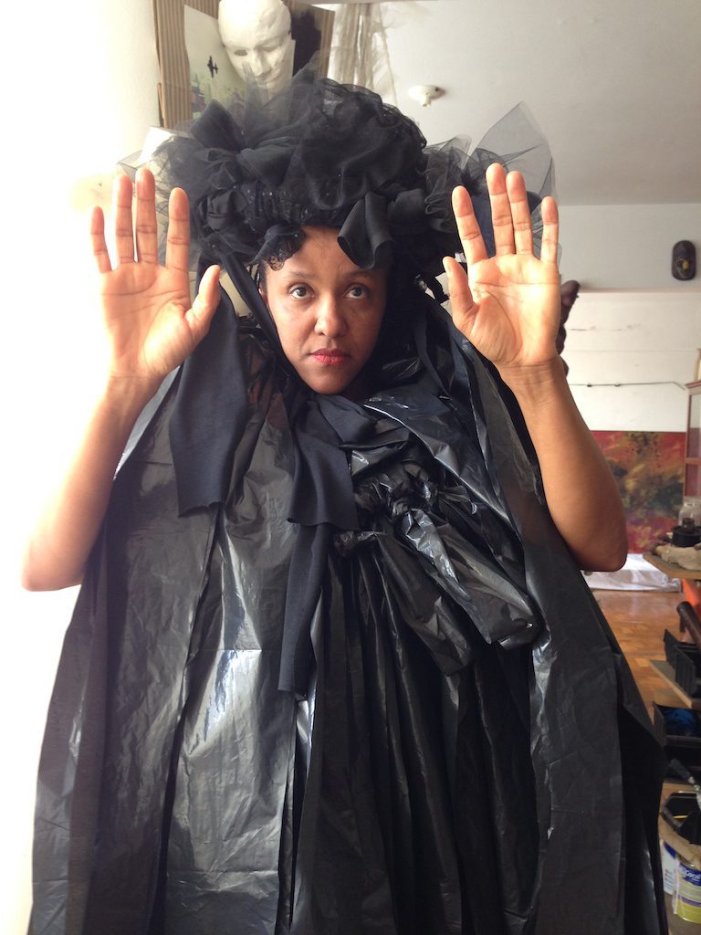 Artist Lidia Lisboa in her studio, wearing one of her creations. Courtesy of the artist