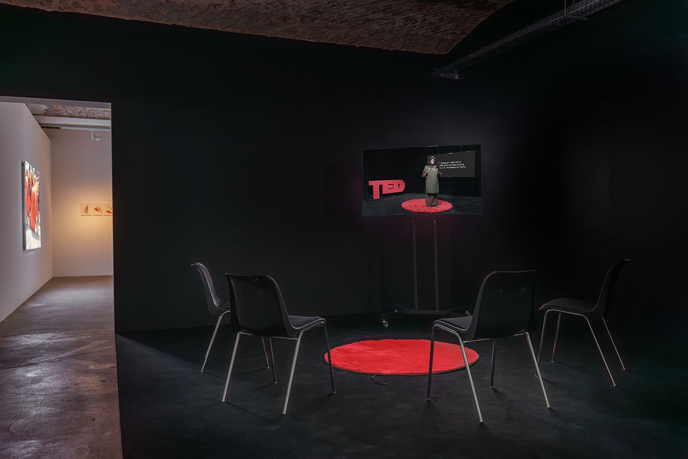 Coco Fusco, TED Ethology: Primate Visions of the Human Mind, 2015. Courtesy the artist (right); Coco Fusco, Bare Life Study #1, 2005. Courtesy Videobrasil Historical Collection (left); Coco Fusco with Dan Turner, A Field Guide for Female Interrogators, 2006/08. Courtesy the artist (back); Installation view of the exhibition “Coco Fusco – Tomorrow, I Will Become an Island” at KW Institute for Contemporary Art, Berlin 2023. Photo: Frank Sperling