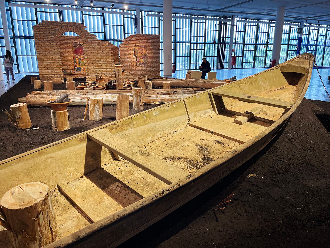 Detail of Castiel Vitorino Brasileiro, Manufacturing the History of Life, 2023. Site-specific installation composed of black soil, fishing boat, alguidars, eucalyptus logs, bricks, corten steel and paintings. Comissioned by Fundação Bienal de São Paulo for the 35th Bienal.