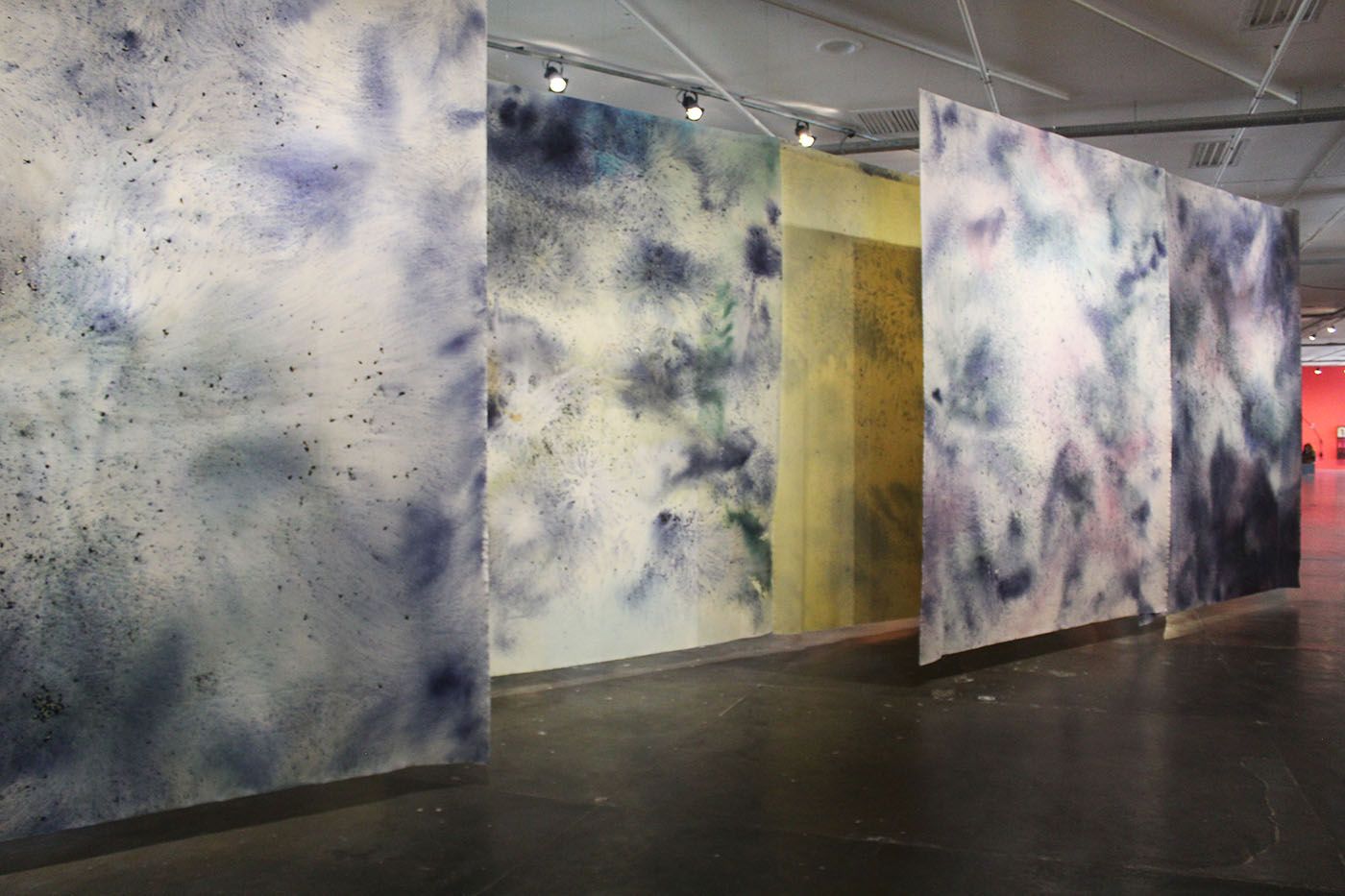 Juliana Dos Santos, Sopro, aragem, viração (2025). Flower petals of Clitoria Ternatea and acrylic on cotton canvas. The piece consists of 7 panels, each measuring 4m x 3,20m. Commissioned by the São Paulo Biennial Foundation for the 36th Bienal. Photo: Cristian Baena