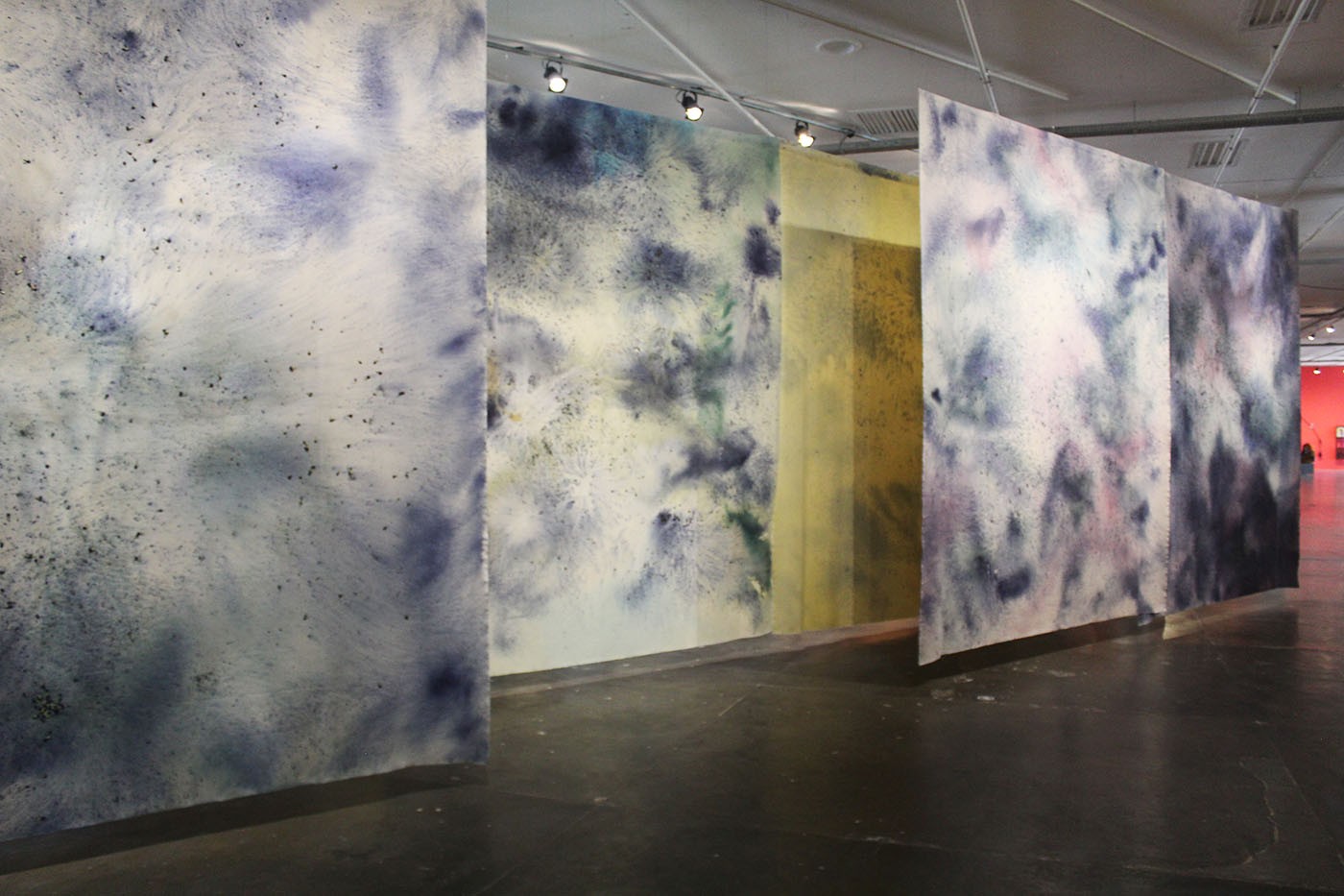 Juliana Dos Santos, Sopro, aragem, viração (2025). Flower petals of Clitoria Ternatea and acrylic on cotton canvas. The piece consists of 7 panels, each measuring 4m x 3,20m. Commissioned by the São Paulo Biennial Foundation for the 36th Bienal. Photo: Cristian Baena