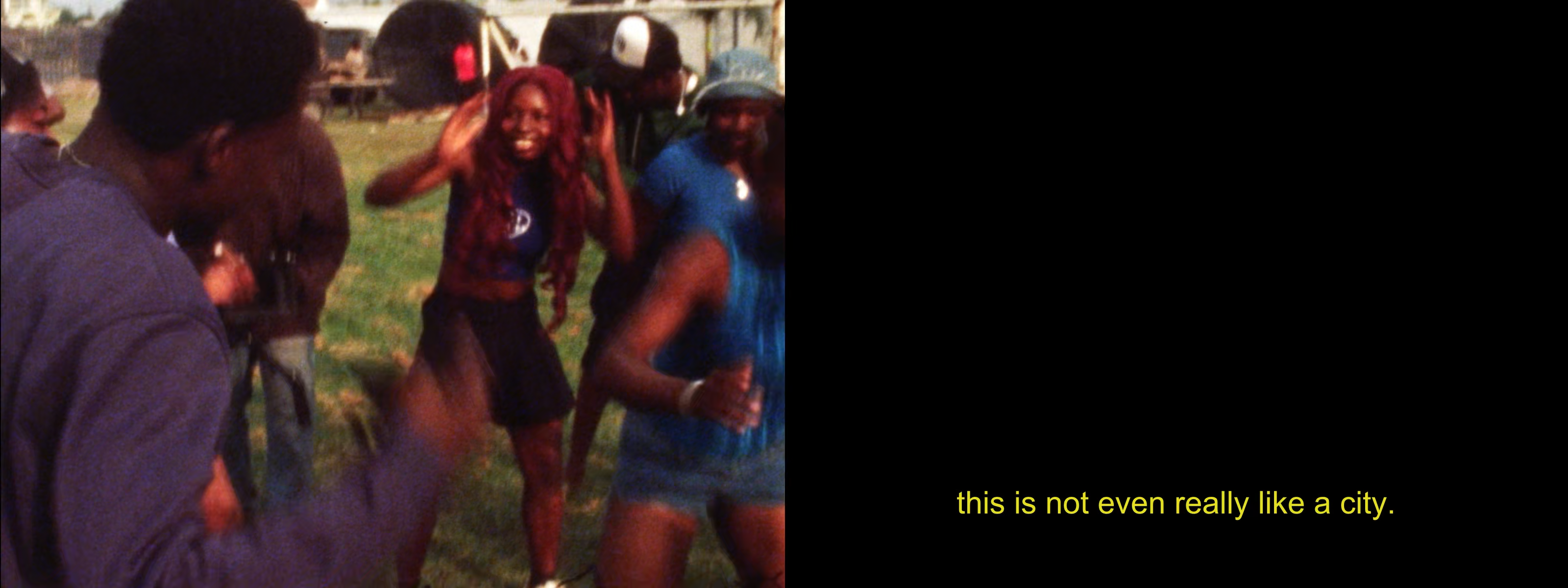 A split image. On the left, a group of joyful Black people dance outdoors, with a smiling woman with red hair prominent. On the right, black space with yellow text: "this is not even really like a city."