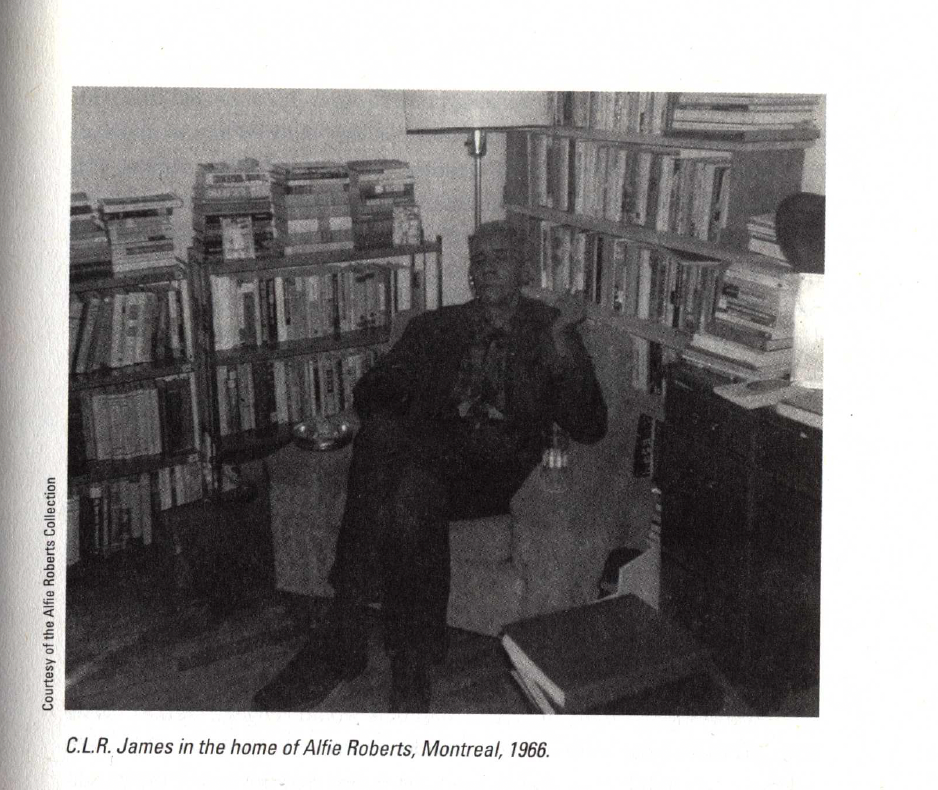 A black and white photo shows C.L.R. James sitting in an armchair, surrounded by bookshelves filled with books.