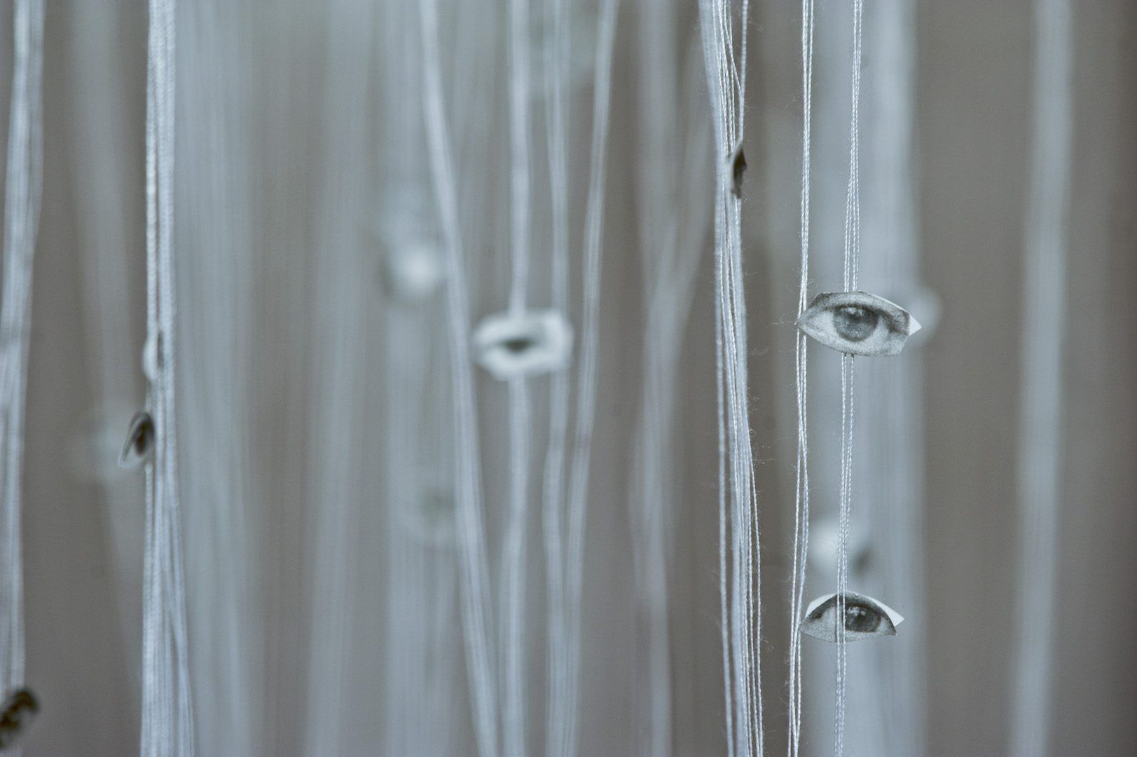 Safaa Erruas, Invisibles, 2011. Installation, cut photos and cotton threads, different sizes. Courtesy of collection CulturesInterface, Casablanca