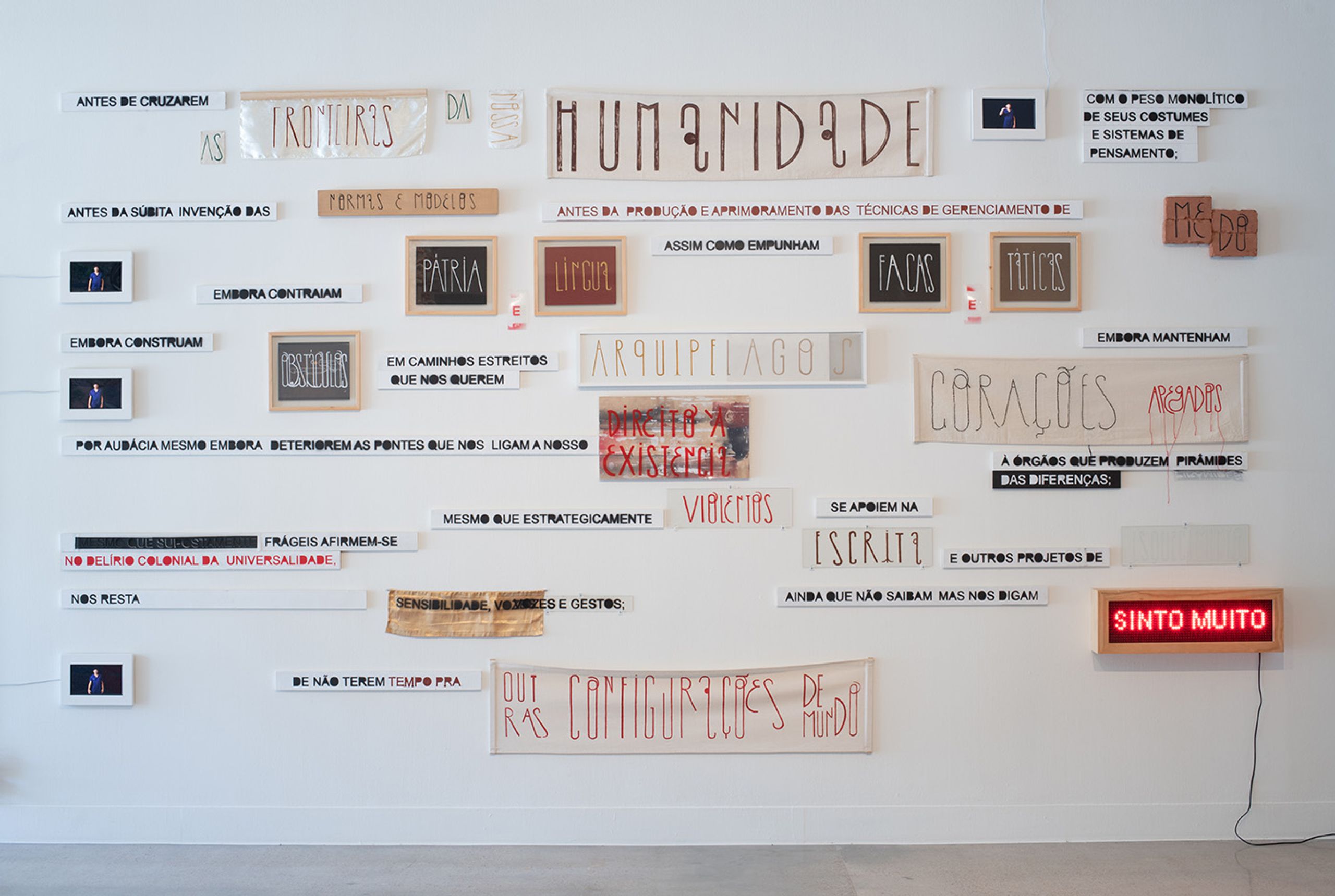 Maré de Matos, Fundamento [Foundation], 2019. Paint on canvas, fabric, clay, wood, acrylic panel, LED sign, video, color, sound. 118 1/8 x 196 7/8 in. (300 x 500 cm). Courtesy of the artist. Social Fabric: Art and Activism in Contemporary Brazil, installation view, Visual Arts Center, The University of Texas at Austin, September 23, 2022 – March 10, 2023. Photo: Sandy Carson
