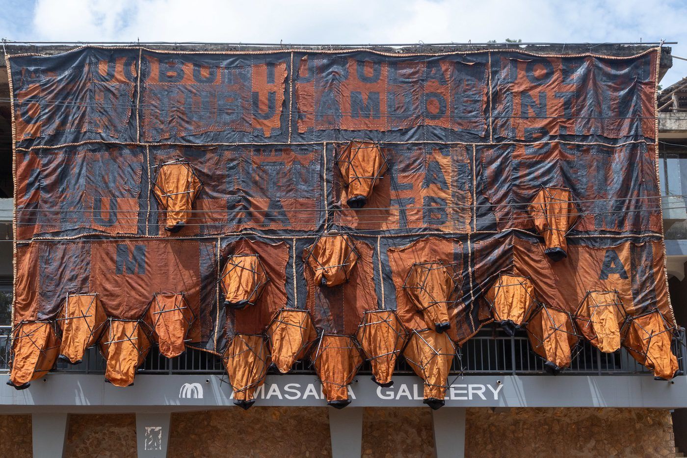 Childhood memoir, 2023, installation from barkcloth, bamboo, cotton, sisal, acrylic paint, nylon, thread, 620 x 1240 x 100 cm. Photo: Wasswa James