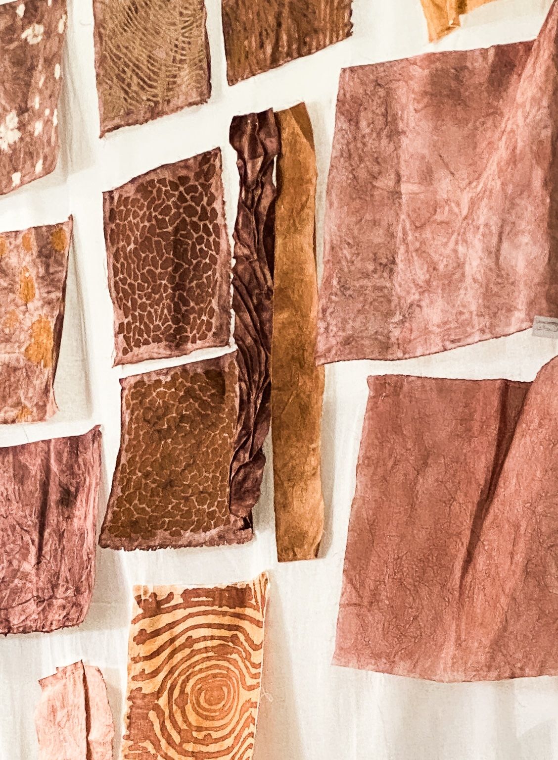 Collection of brown and rust fabric swatches with diverse natural patterns and textures.
