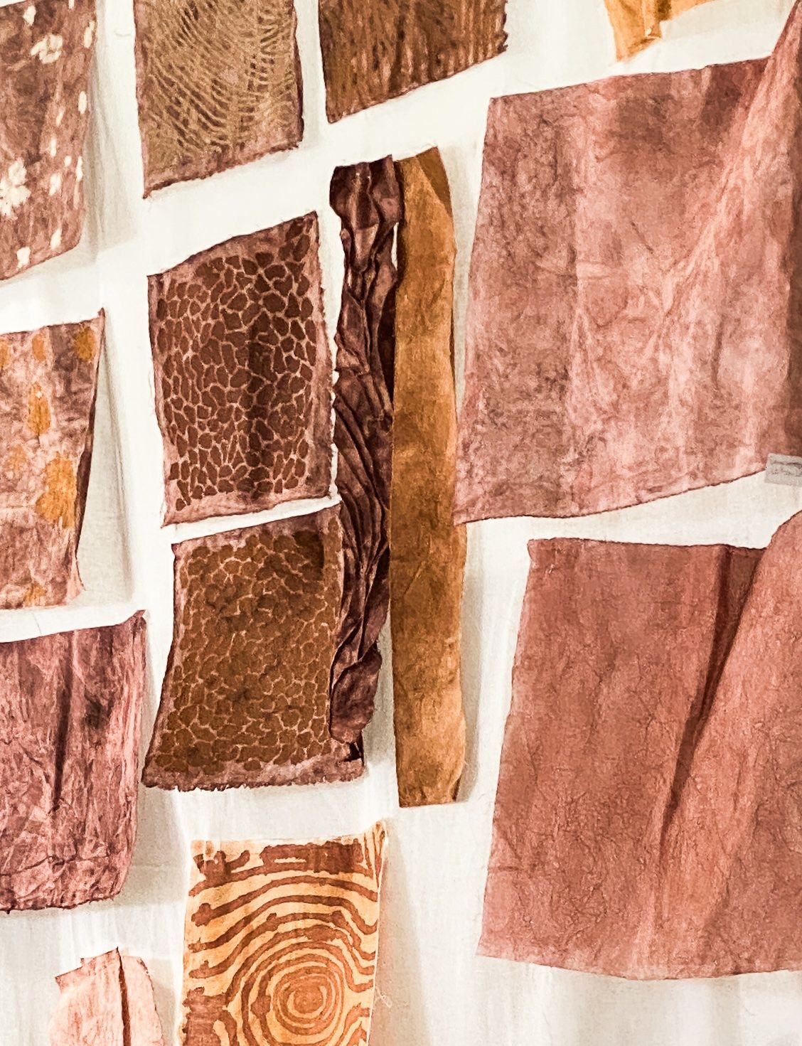 Collection of brown and rust fabric swatches with diverse natural patterns and textures.