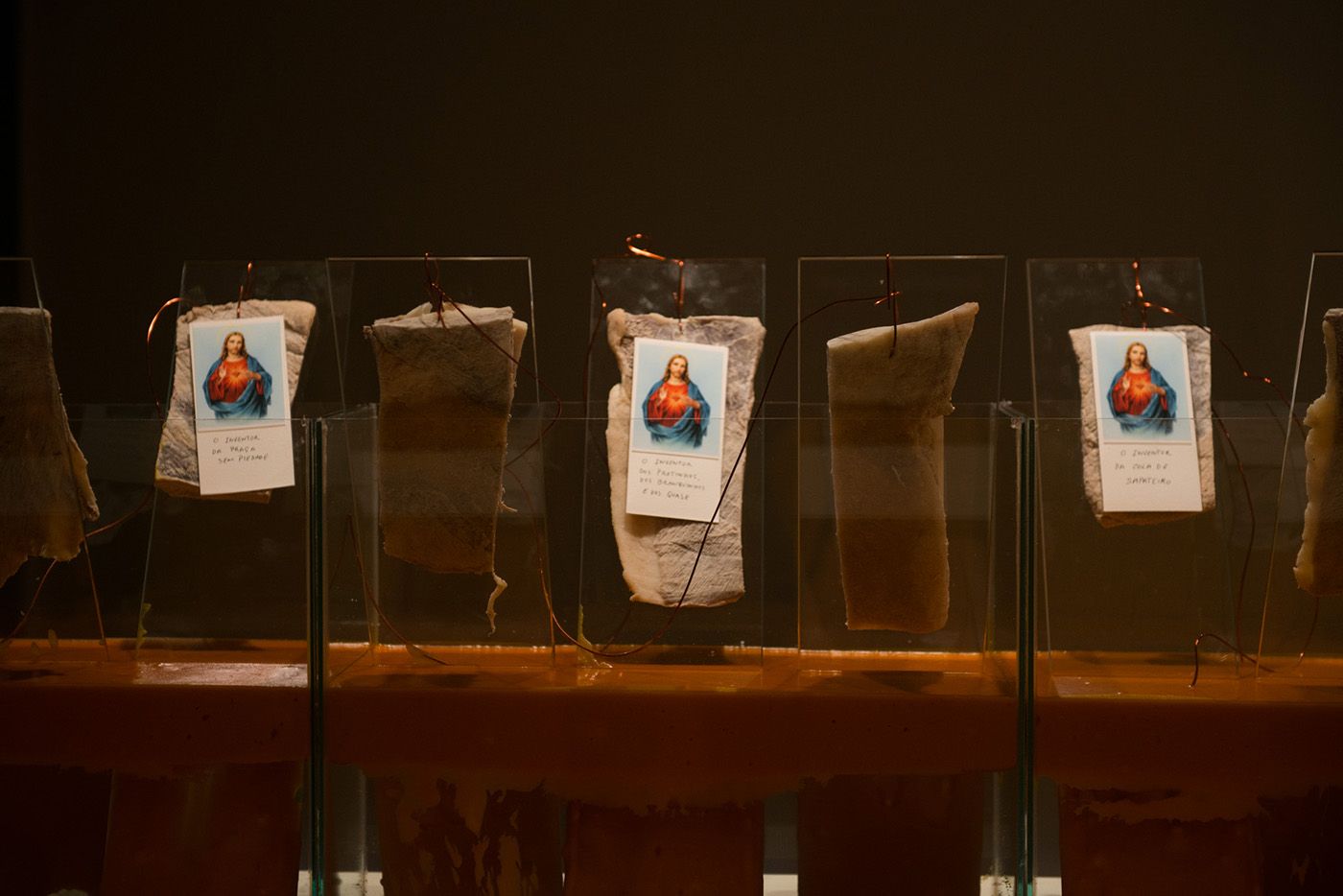 Ayrson Heráclito, Kiry Beuys Salvador, 1995 - 2022, glass aquariums, meat, religious saints, copper wires. Exhibition copy. Photo: Levi Fanan/Pinacoteca de São Paulo