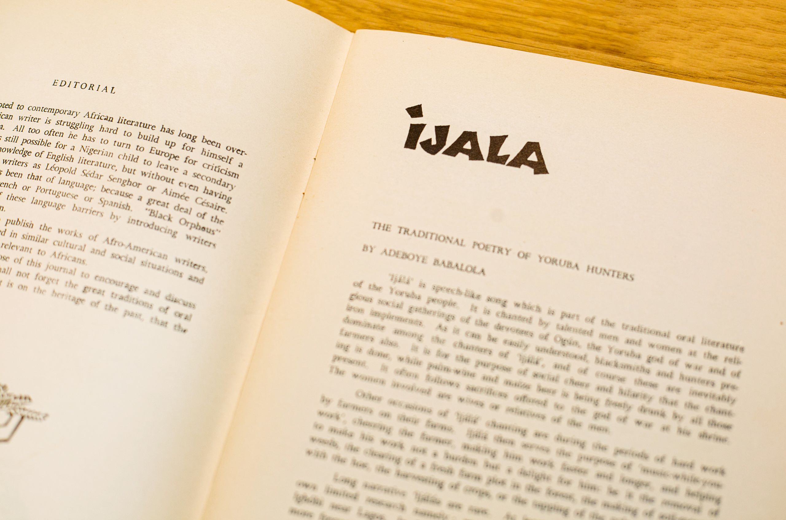 Open book with pages showing an "EDITORIAL" on the left and an article titled "iJALA: The Traditional Poetry of Yoruba Hunters" on the right.