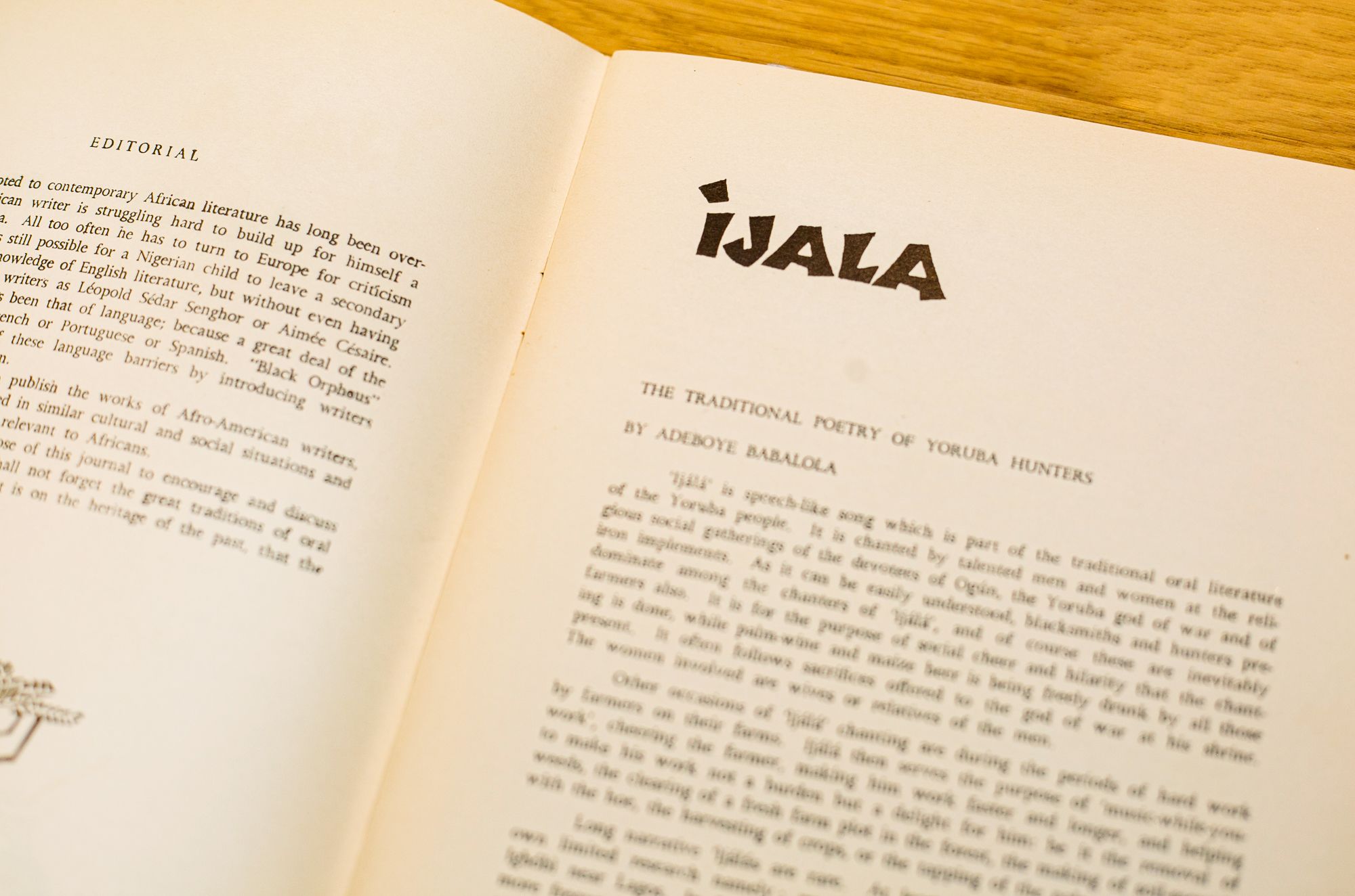 Open book with pages showing an "EDITORIAL" on the left and an article titled "iJALA: The Traditional Poetry of Yoruba Hunters" on the right.