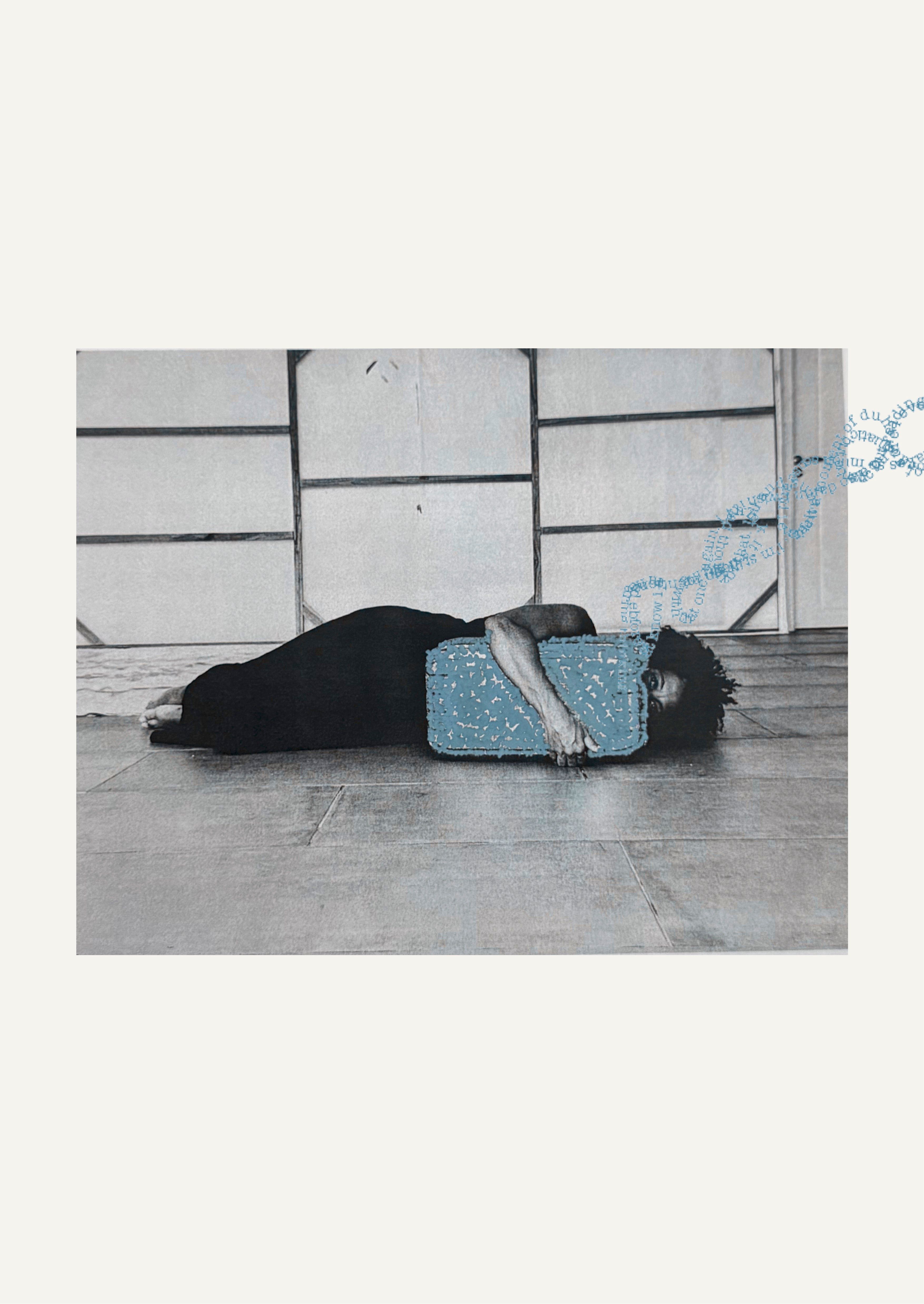 Black and white image of a woman lying on her side, head resting on a textured blue block, with a blue DNA-like swirl of text above her.