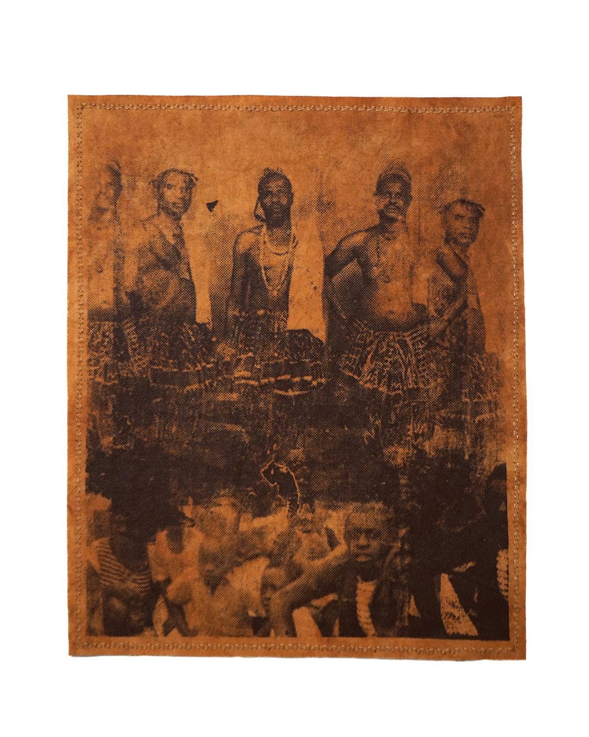 Sepia-toned image on rectangular leather with a stitched border, depicting five standing men in patterned skirts over a darker, indistinct crowd.