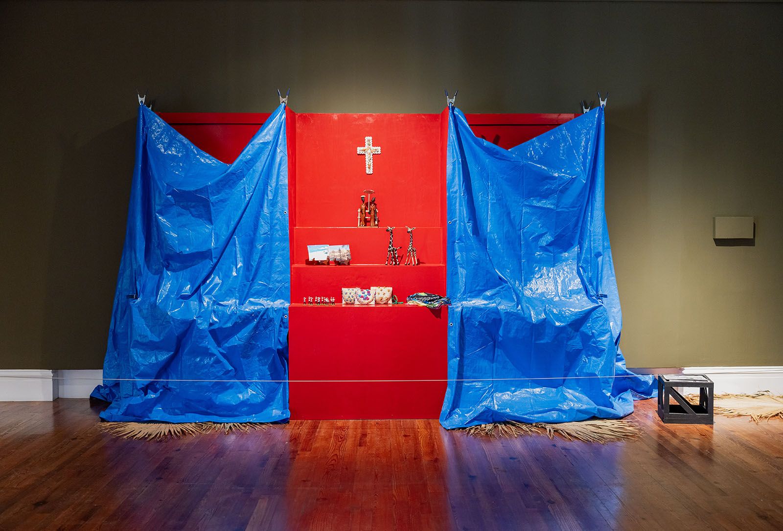 Jodi Minnis, Everyone's Business. Acrylic paint, hair beads, metal fencing, plaster, polyethylene tarp, straw plait, synthetic hair, dimensions variable, 2024. Collection of the Artist. Photo: Jackson Petit-Homme. Courtesy of the National Art Gallery of The Bahamas