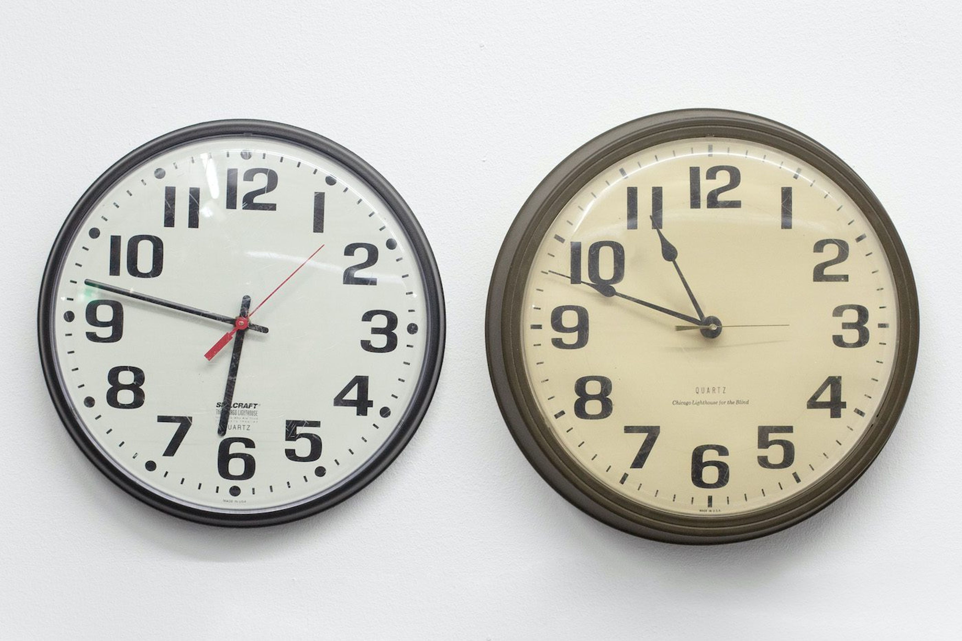 James Gregory Atkinson, CST/CET Office (Detail), 2021, clocks, photography, counter, installation view, ‘6 Friedberg-Chicago’, Dortmunder Kunstverein . Courtesy: the artist, Germericans (Sabrina und Marvin Kuhn), Dortmunder Kunstverein. Photo: Jens Franke
