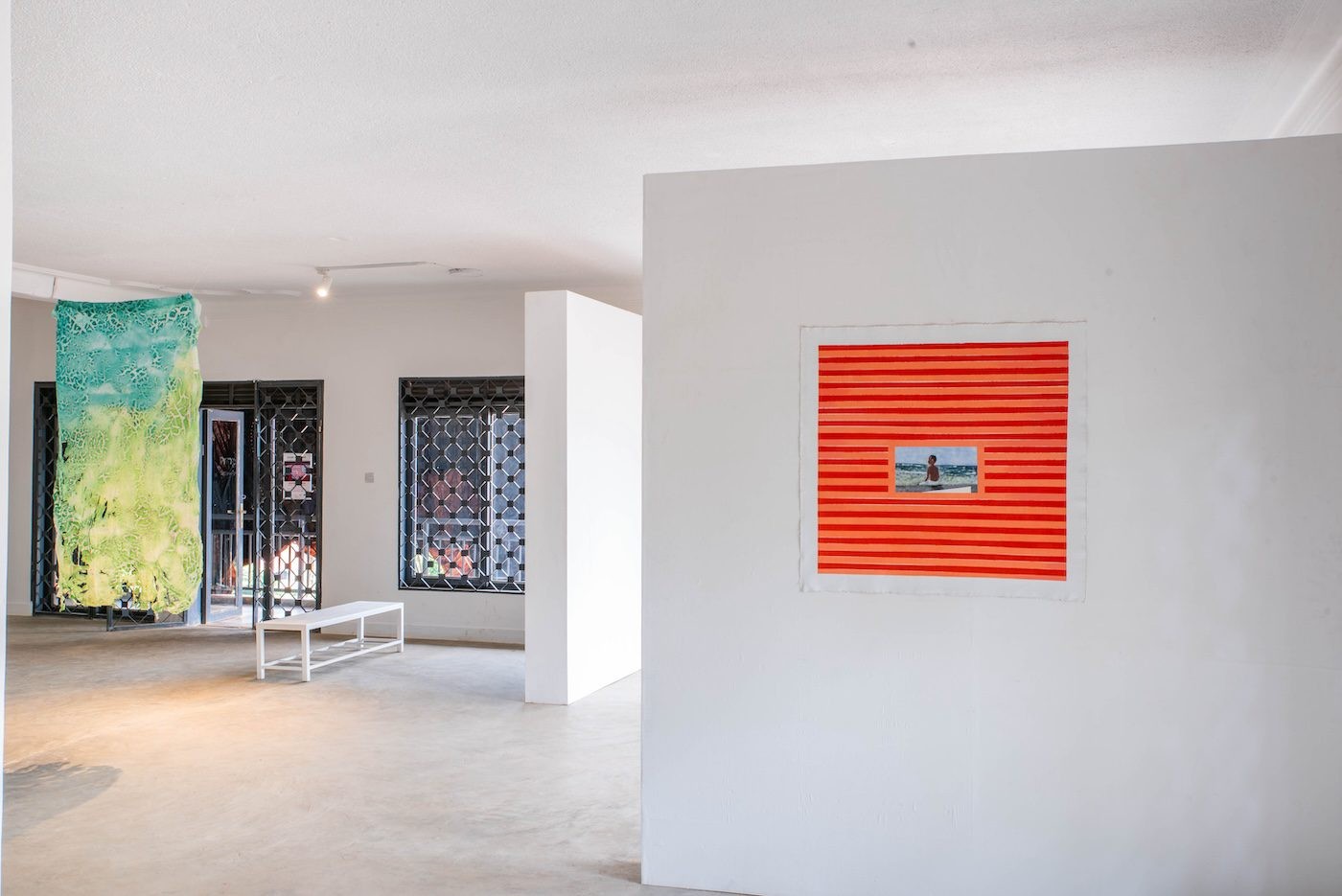 Installation view, Tracy Naa Koshie Thompson, Blue noodles, 2021, noodles, 205 x 105 cm and Dan ‘Ngaara’ Ngalamulume, Skydream III, 2023, Acrylics on canvas, 83.5 x 87 cm at Silent Invasions: The Art of Material Hacking. Photo: Atiko Anthony