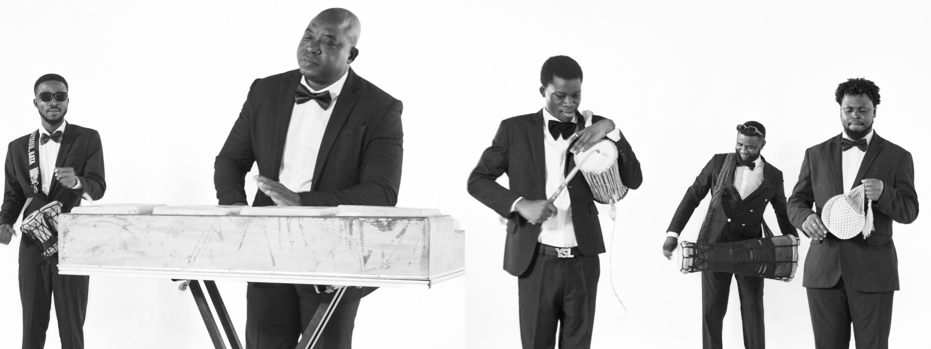Black and white photo of five men in suits and bow ties playing various musical instruments, including a keyboard, talking drum, and percussion.