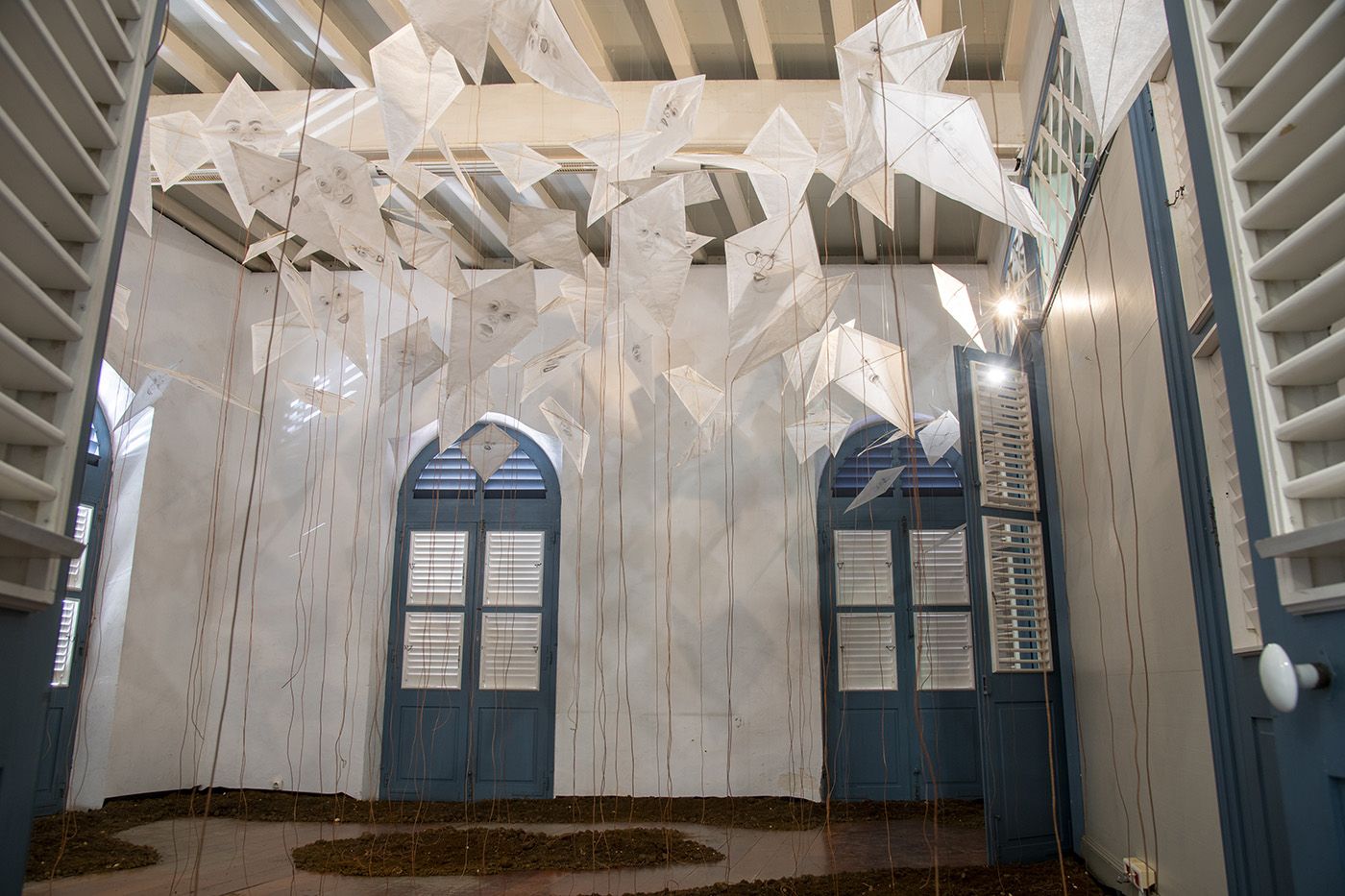 Guy Gabon, RELIANCE, installation, drawings on paper kites, leather threads, earth, Médiathèque, 2023. Photo: Daniel Dabriou.