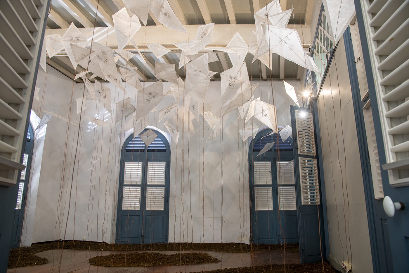 Guy Gabon, RELIANCE, installation, drawings on paper kites, leather threads, earth, Médiathèque, 2023. Photo: Daniel Dabriou.